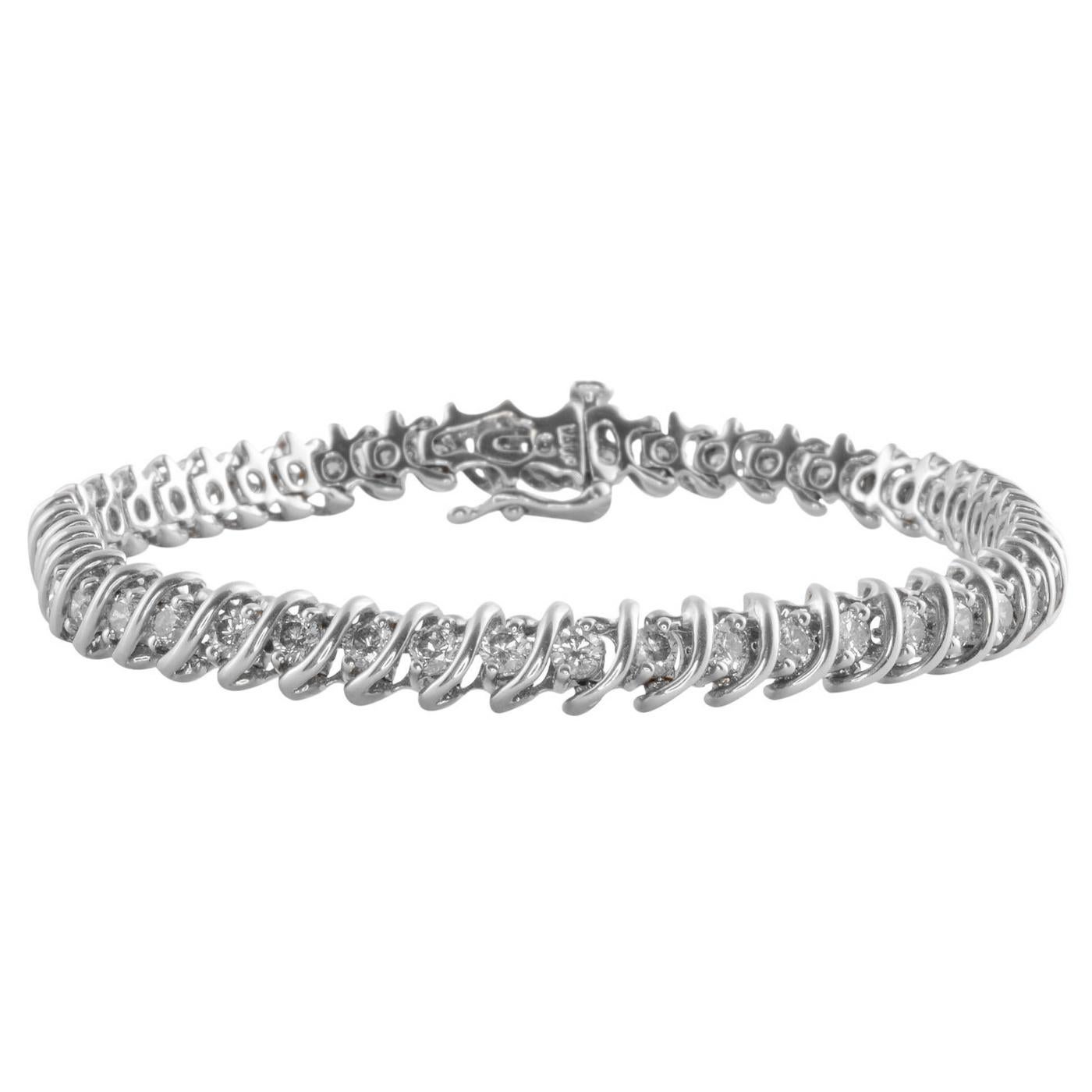 Classic Diamond tennis bracelet Stylized. This 18 karat White gold tennis bracelet features diamonds at 2.5 carat total weight in s-shaped links. The diamonds have Si1 clarity and G-H color. This diamond tennis bracelet weight 18
