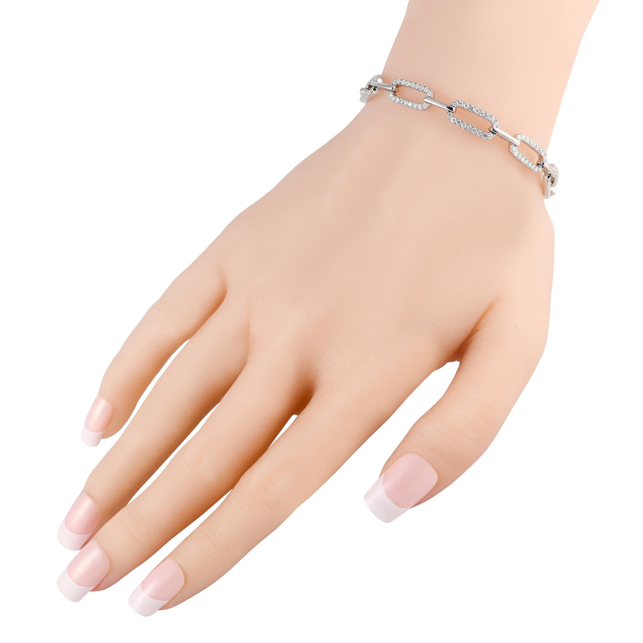 Bold links accented by sparkling diamonds totaling 2.50 carats make this fabulous bracelet a luxury piece that will complement any aesthetic. Crafted from 18K white gold, this elegant accessory measures 7.25 long.This jewelry piece is offered in