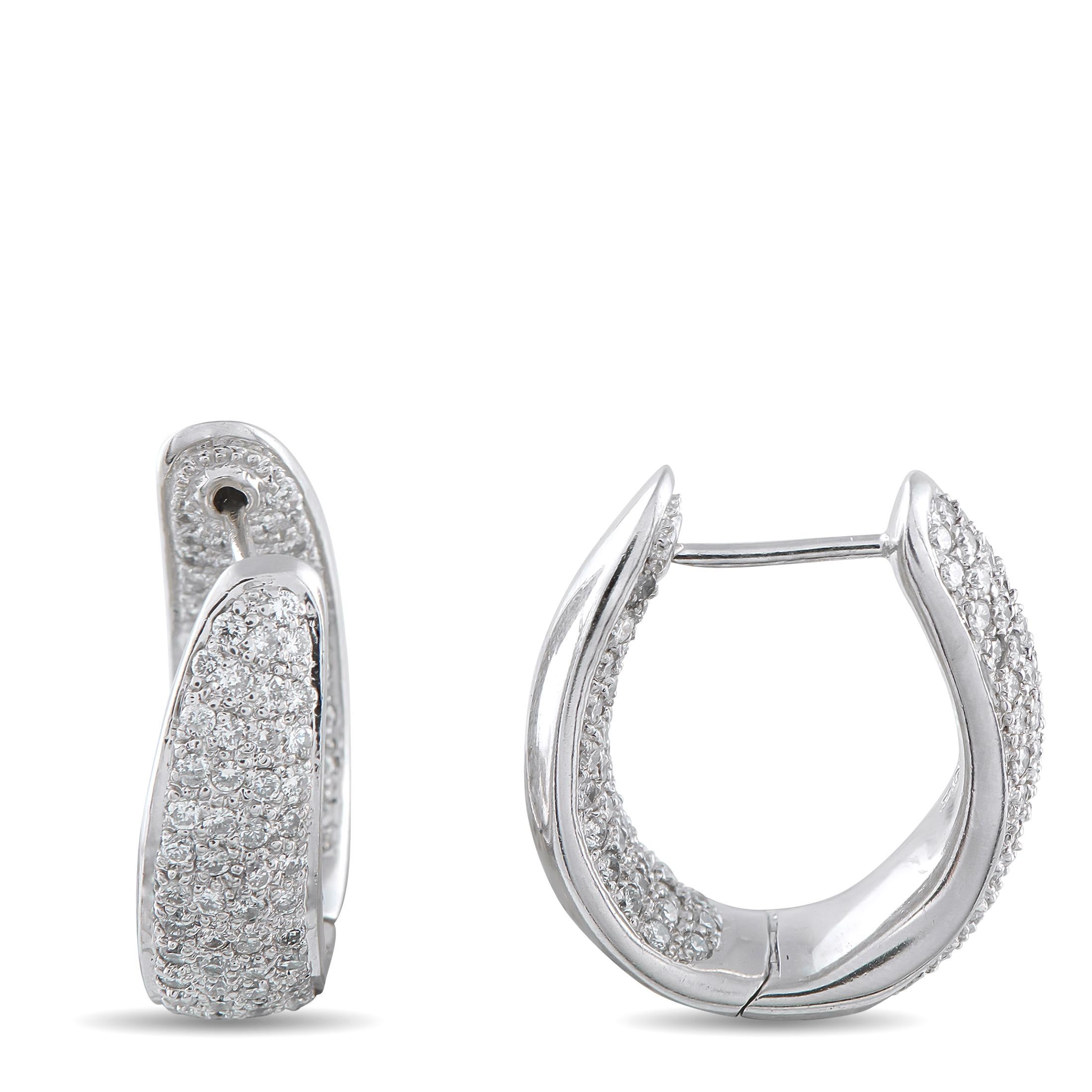 A minimalist design makes these luxury hoop earrings an instant classic. Thoughtfully placed Diamonds totaling 2.60 carats accent the curved 18K White Gold settings, allowing them to sparkle and shine from virtually any angle. Each earring measures