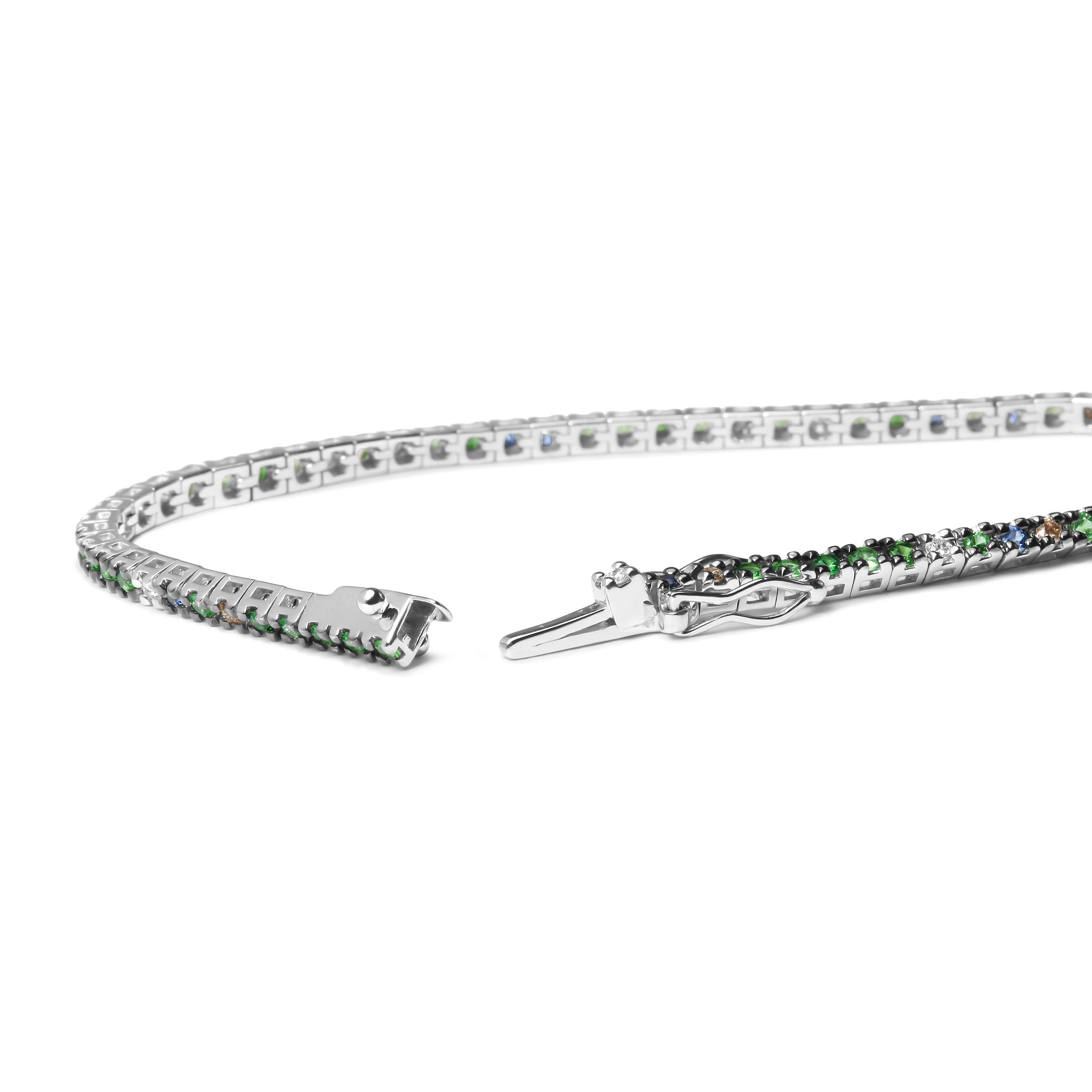 This 18k white gold tennis bracelet is a stunning piece that is perfect to pair with any outfit choice. An array of colorful diamonds and gemstones enhance the look and give it a unique flair that you will love to show off.  Round white diamonds and