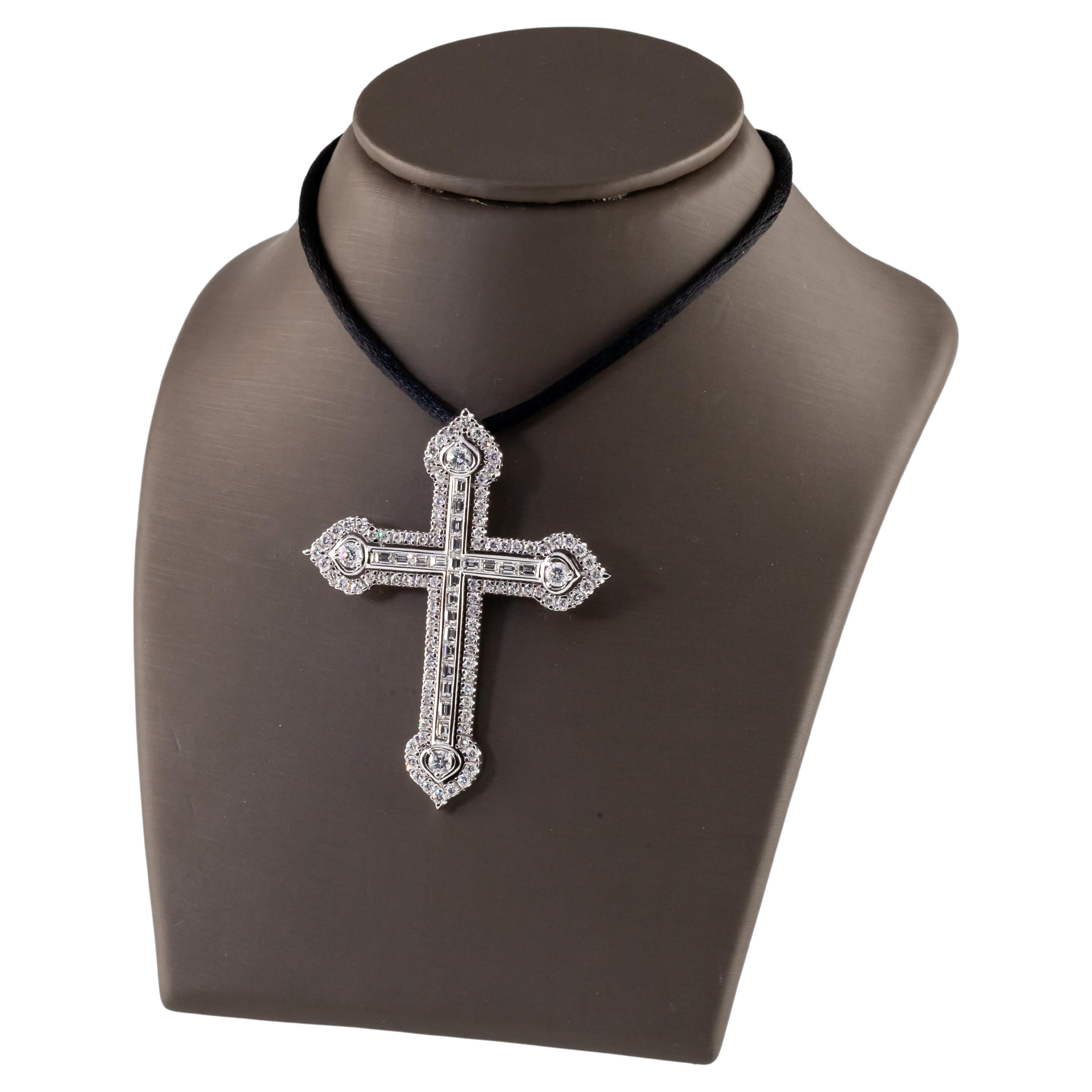 Gorgeous Diamond Cross Pendant in 18k White Gold
Features Channel Set Baguette Diamonds on Interior of Cross with Pave Set Round Diamond Bezel
Each Terminus Has Single Prong Set Round Solitare Stone
Total Diamond Weight = Appx 3 Carats
Average Color