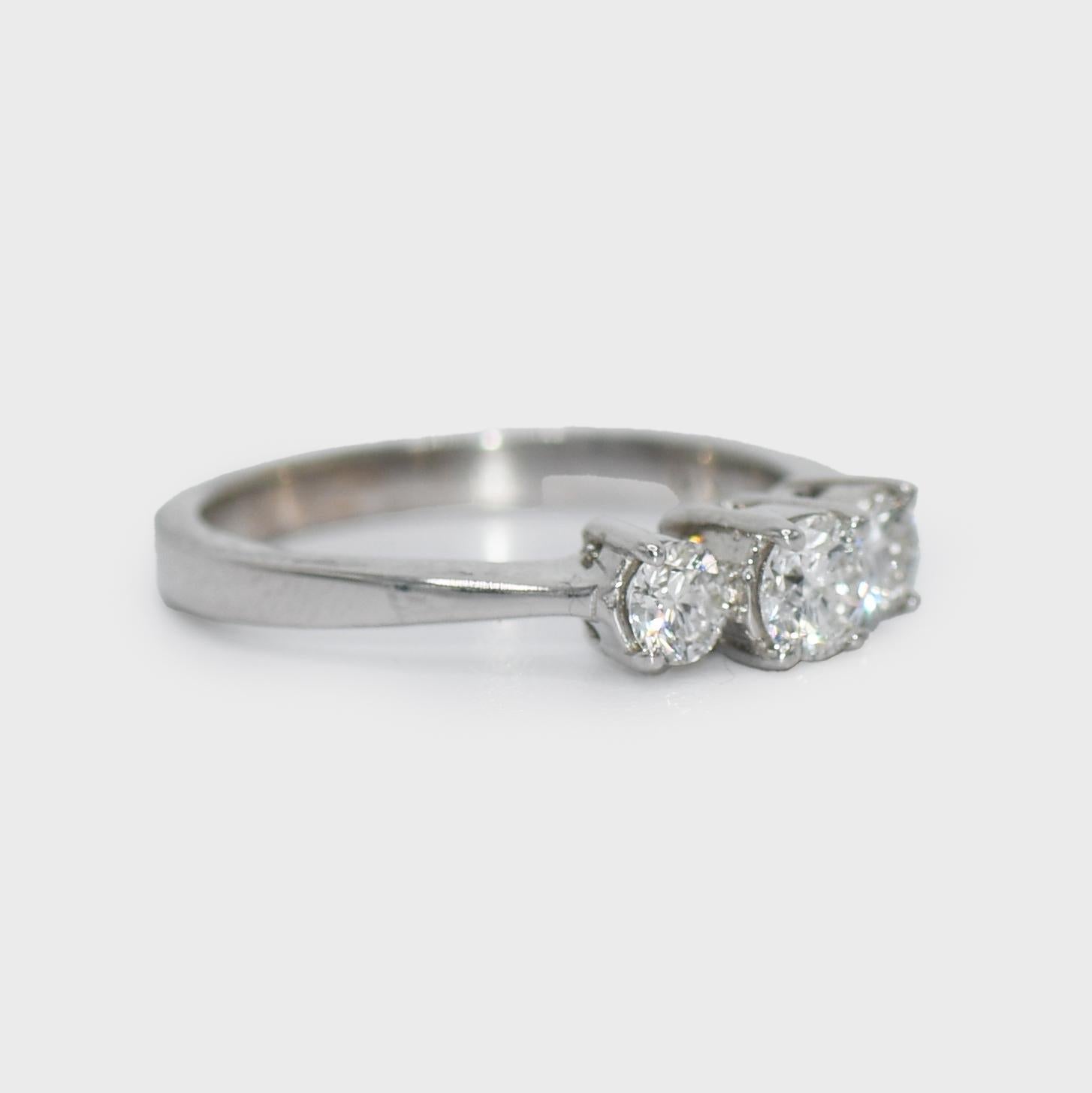 18K White Gold 3 Stone Diamond Ring .50tdw, 3.2gr
18k White Gold Diamond Ring. The ring weighs 3.2gr and is stamped 18k
There are three Round Brilliant Cut Diamonds, Center stone is .20ct, and both side stones are .15ct each. .50tdw 
Clarity is