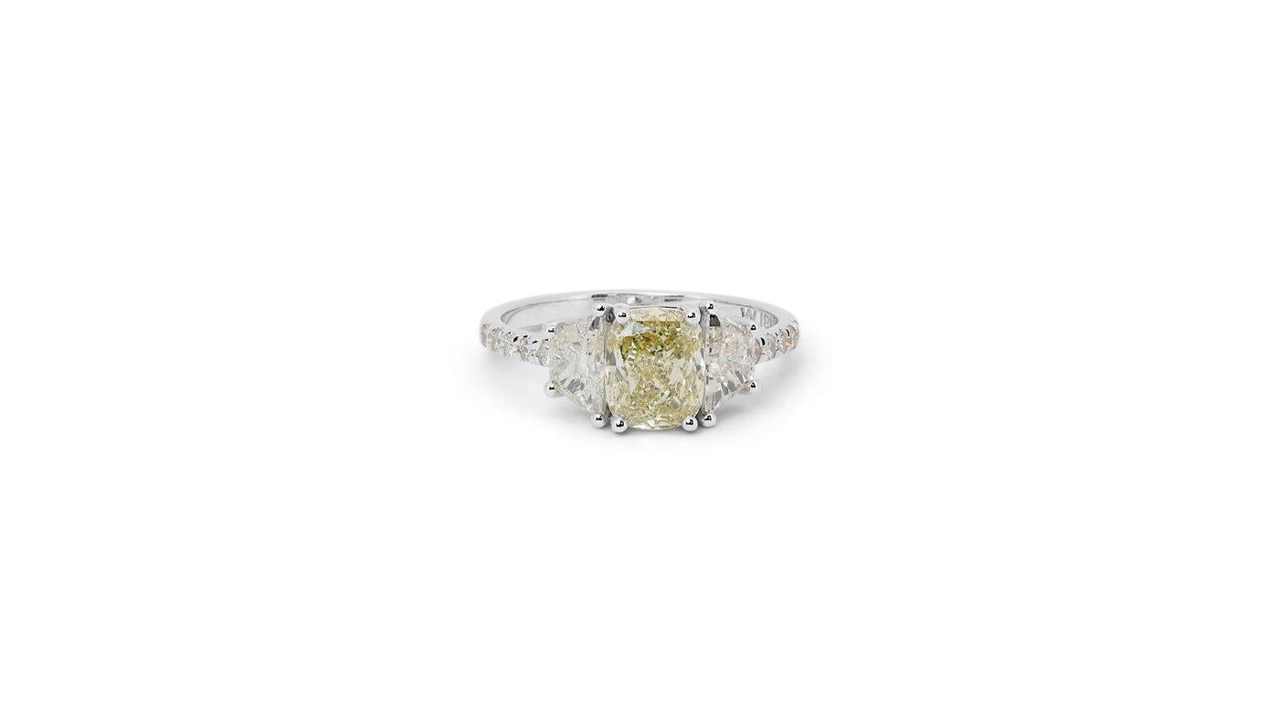 A stunning three stone pave ring with a dazzling 1.51 carat cushion shape natural diamond. It has 0.77 carat of side diamonds which add more to its elegance. The jewelry is made of 18K White Gold with a high quality polish. It comes with GIA & AIG
