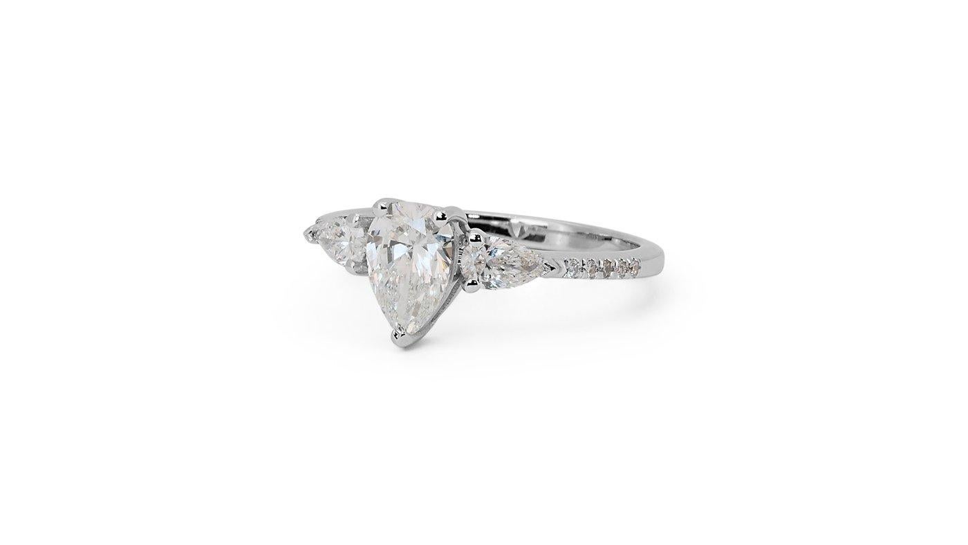 A beautiful 3 stone ring with a dazzling 0.9 carat pear brilliant natural diamond. It has 0.41 carat of side diamonds which add more to its elegance. The jewelry is made of 18K White Gold with high-quality polish. It comes with a GIA certificate and