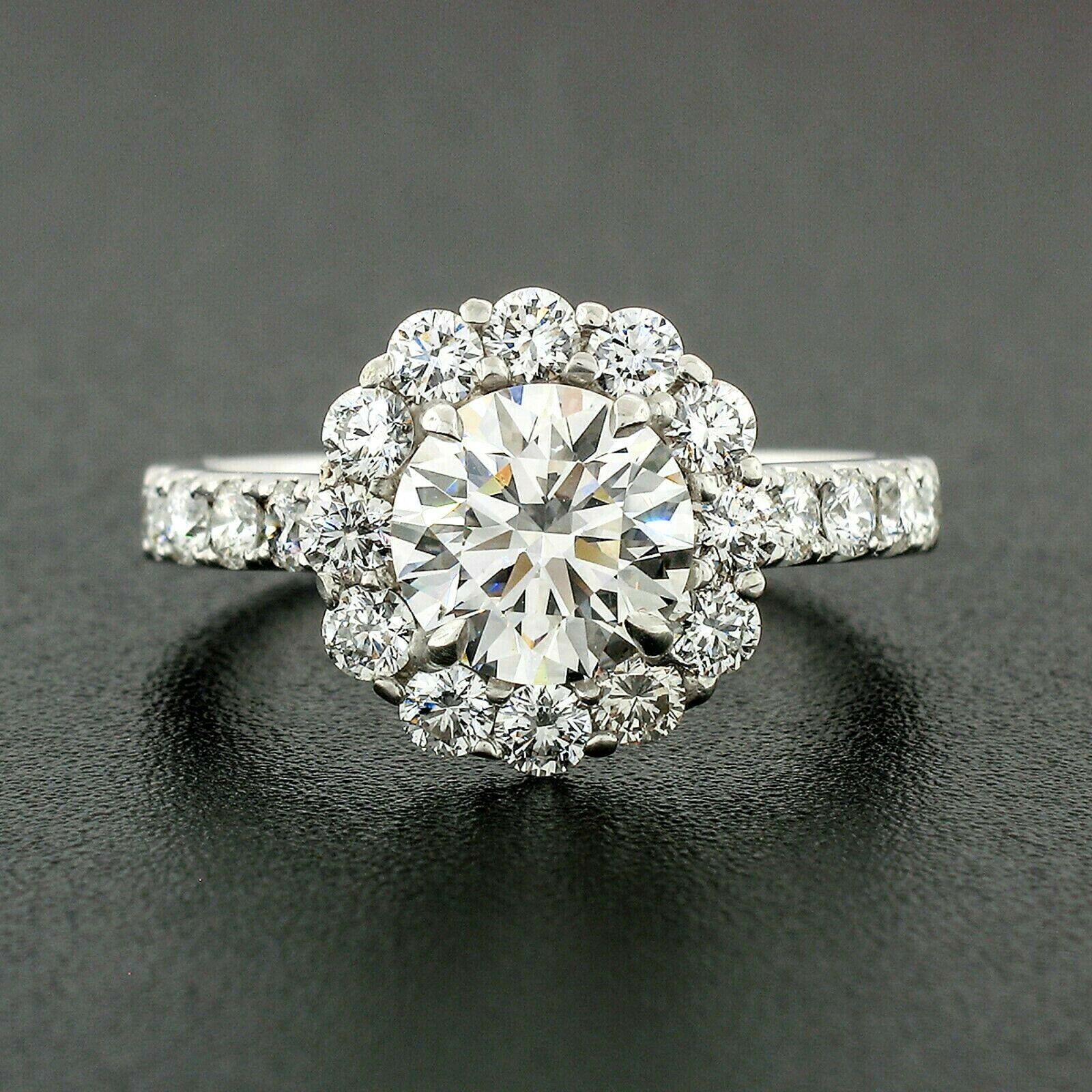 This gorgeous custom made diamond engagement ring is newly crafted from solid 18k white gold. It features a GIA certified center stone that weighs exactly 1.53 carats with near-colorless H color and very clean VS2 clarity. It is a truly breathtaking