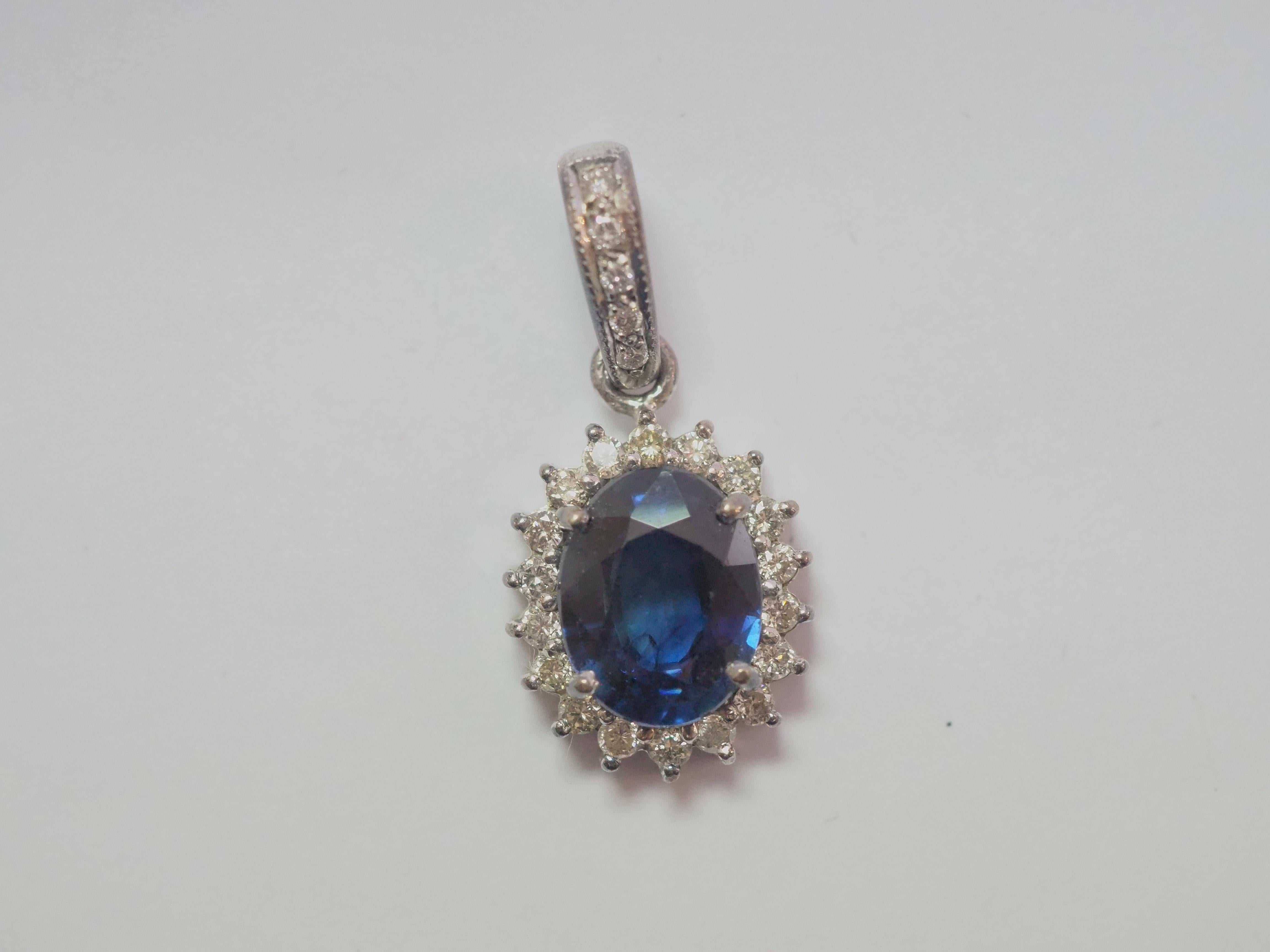 A beautiful and quality cocktail pendant enhancer. This beautiful piece is crafted in our workshop using 18K white gold. The piece is adorned with a gorgeous 3.33 carats oval well- saturated blue sapphire and with 0.42 carats of brilliant diamonds