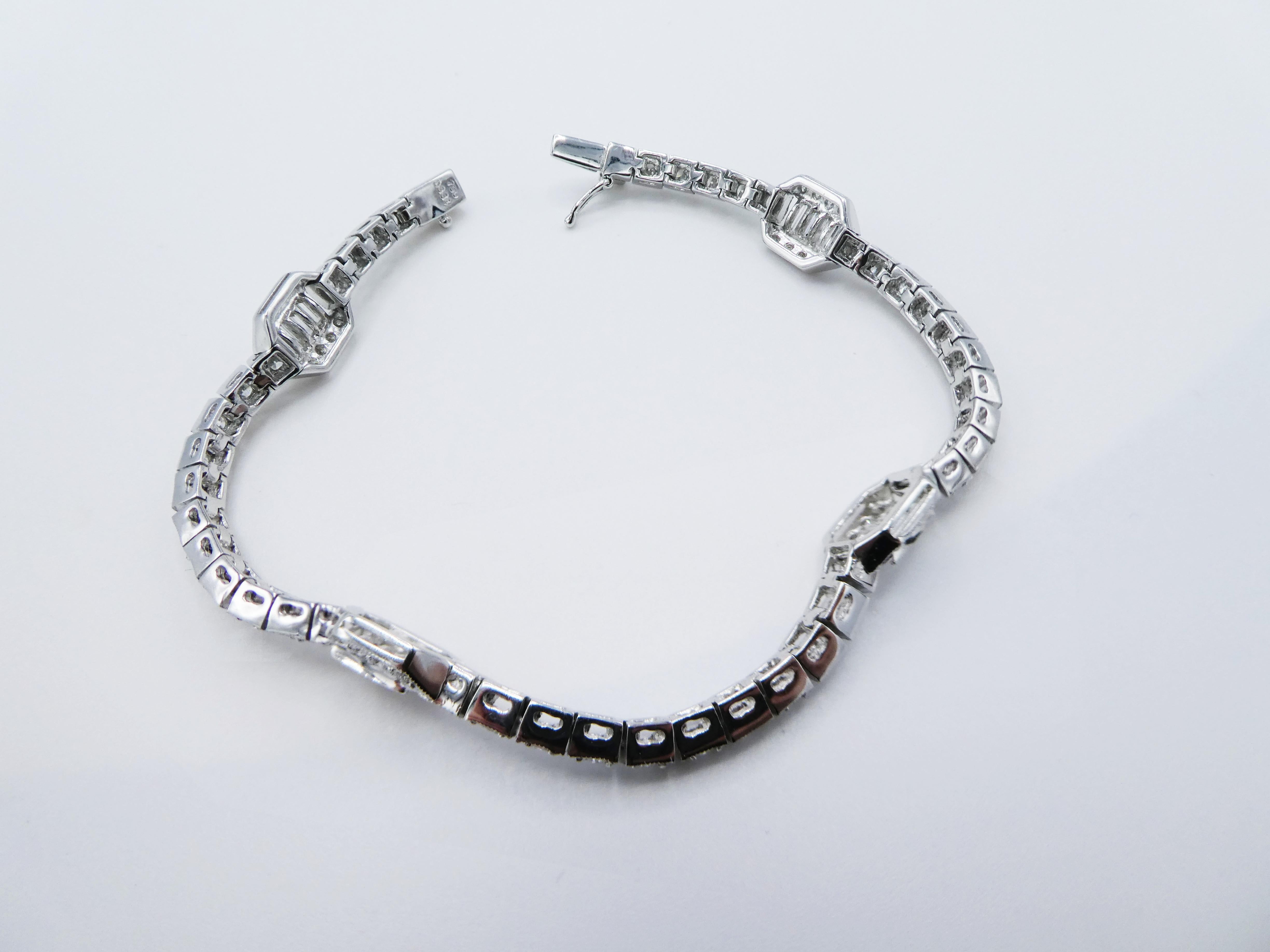 18K White Gold Art Deco Style Diamond Tennis Bracelet 3.34 CTW 

Metal: 18K white gold
Weight: 15.03 grams
Diamonds: 76 Round brilliant and 12 baguette diamonds, 3.34 CTW (marked on clasp) G VS 
Length: 7 inches
Width: 7.9mm at widest, 3mm at