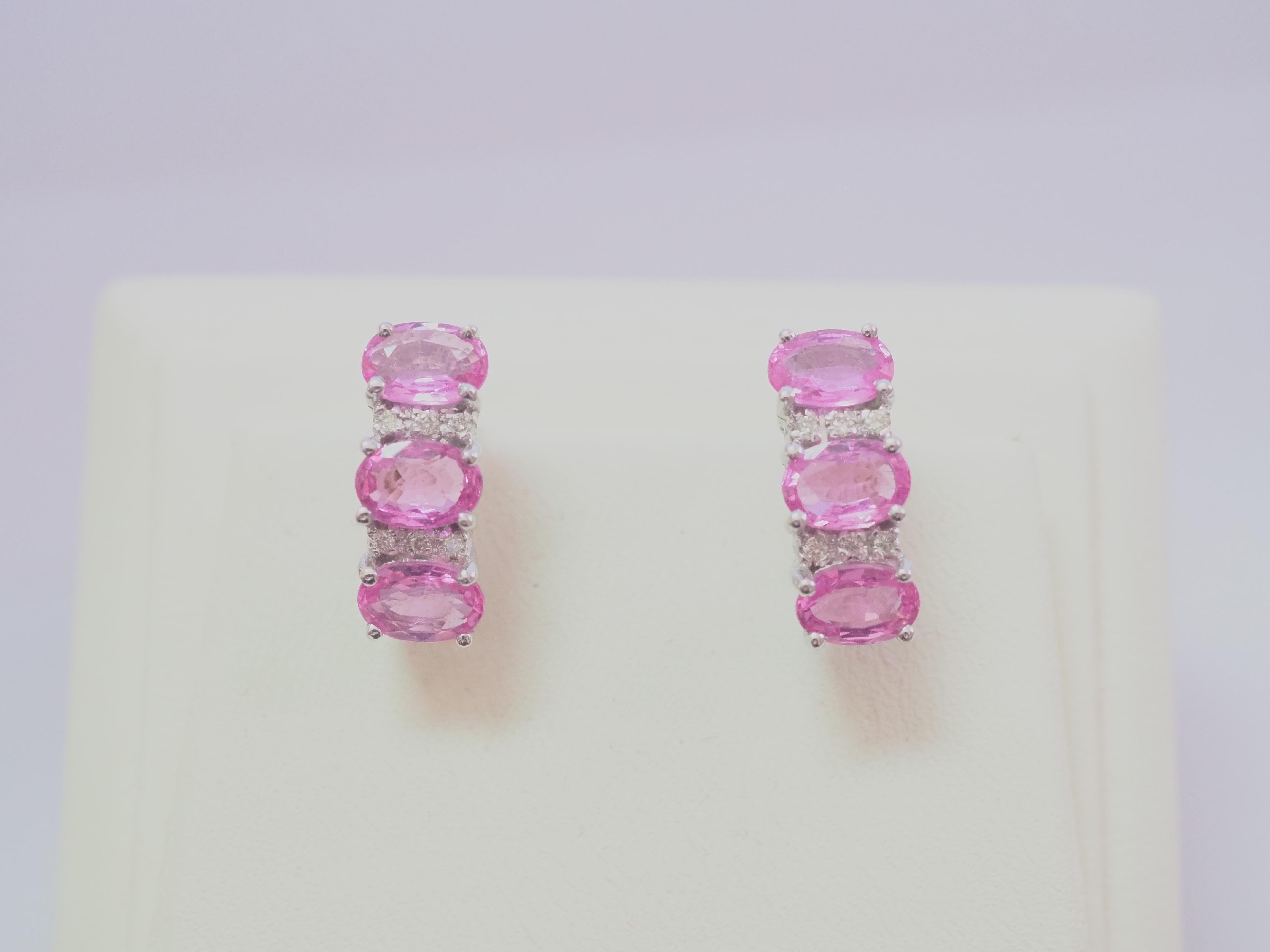 Beautiful latch back earrings made in the 1990's and has never been worn. The earrings have the shape of half circular hoop. There are 6 decent sizes of oval pink sapphires in total and therefore 3 for each ear. The sapphires are all set in prong