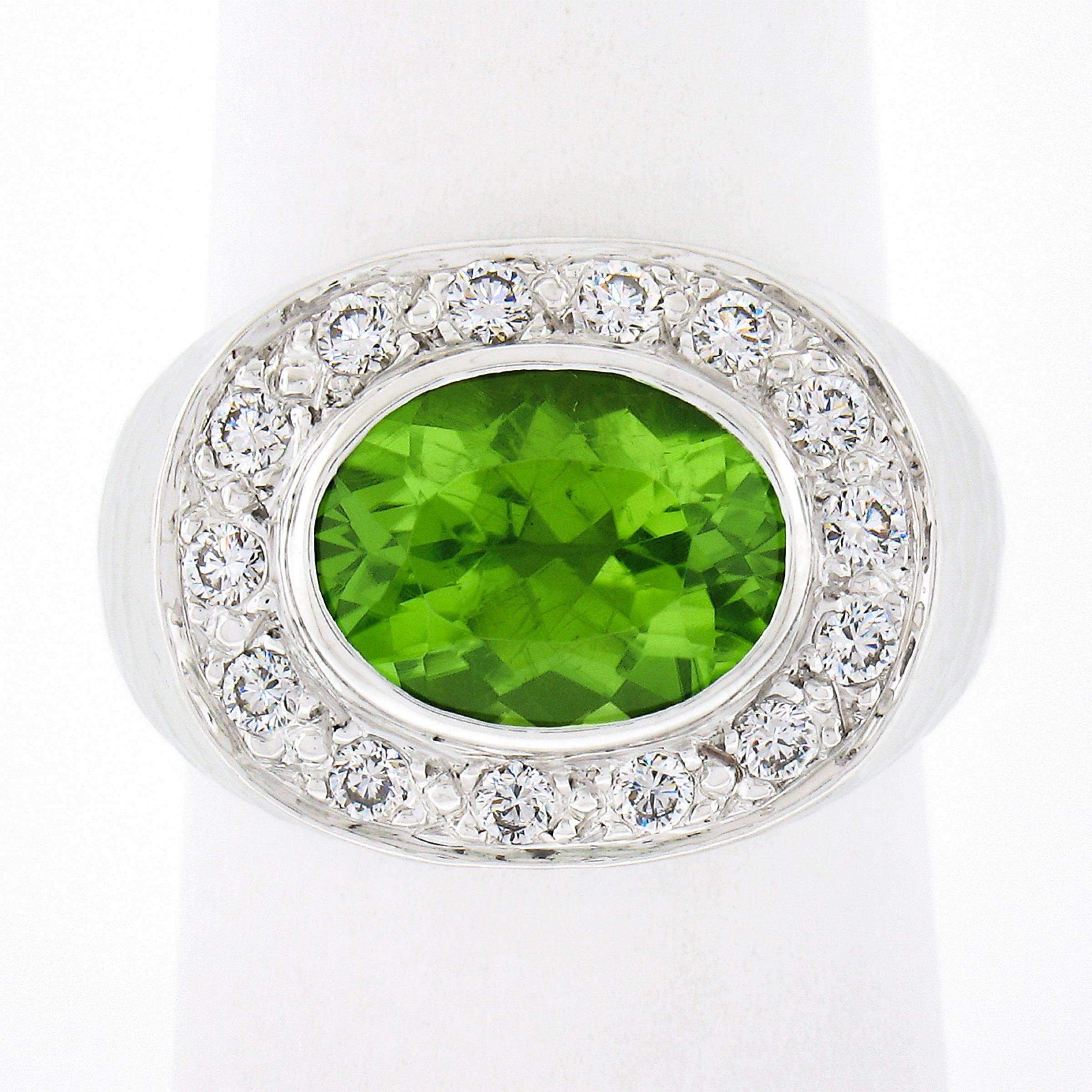 Here we have an absolutely magnificent cocktail ring that is crafted from solid 18k white gold featuring a large peridot gemstone that is perfectly accented with very fine quality diamonds. The oval brilliant cut peridot weighs approximately 3.62