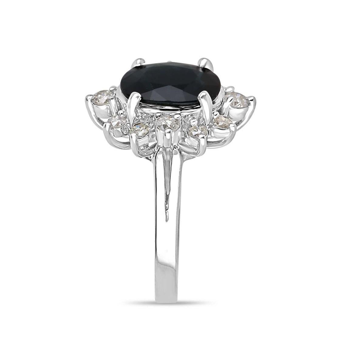 Indulge in the allure of sophistication with this exquisite ladies' sapphire and diamond ring. A mesmerizing 3.51-carat oval-cut sapphire takes the spotlight, boasting an intense dark blue hue, translucent clarity, and a captivating luster.
