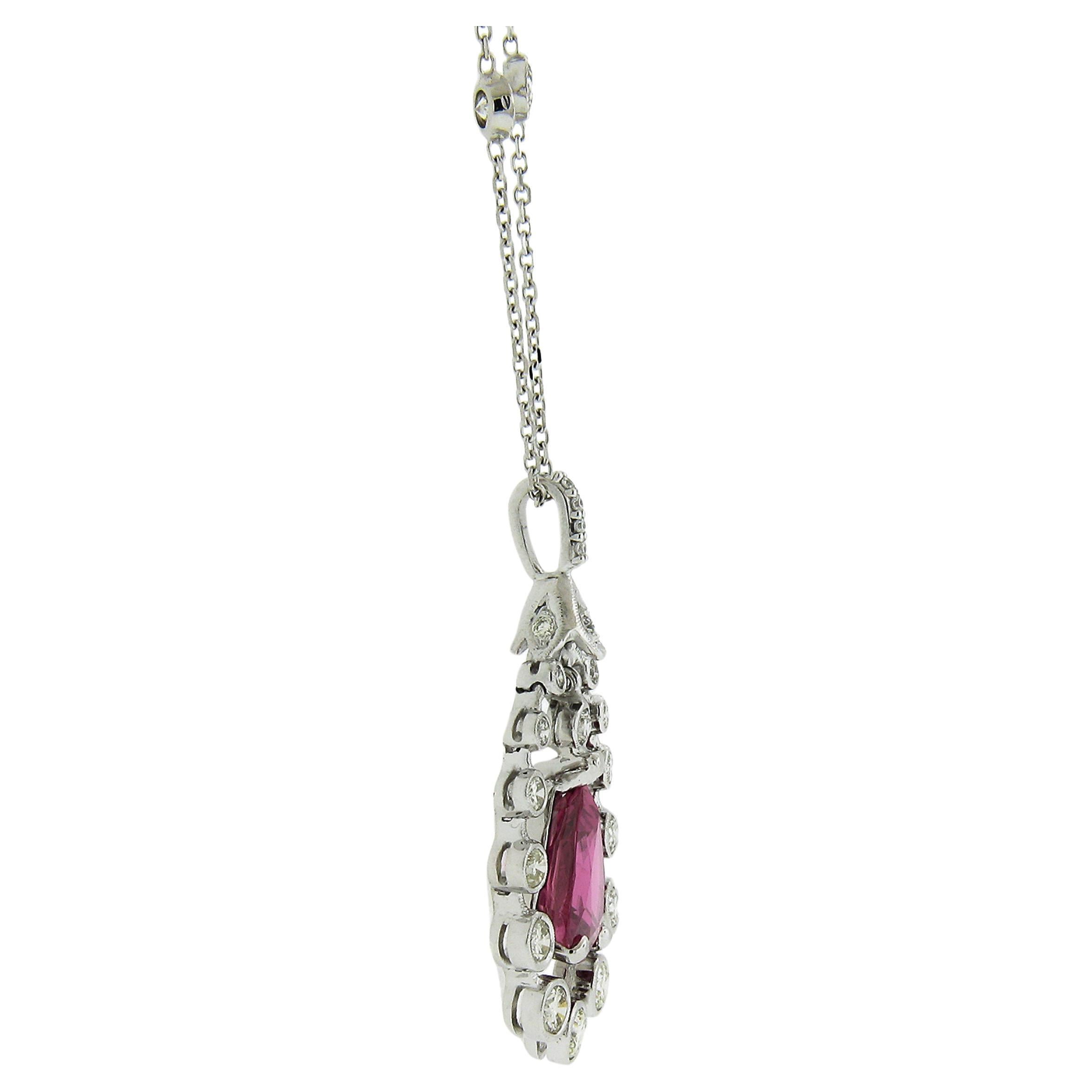 This classy and elegant necklace features an incredible teardrop pear cut ruby that dangles at the center of the diamond halo. The halo is flexible in design and gives this piece its special visual effects. The pendant slides on a fancy diamond by