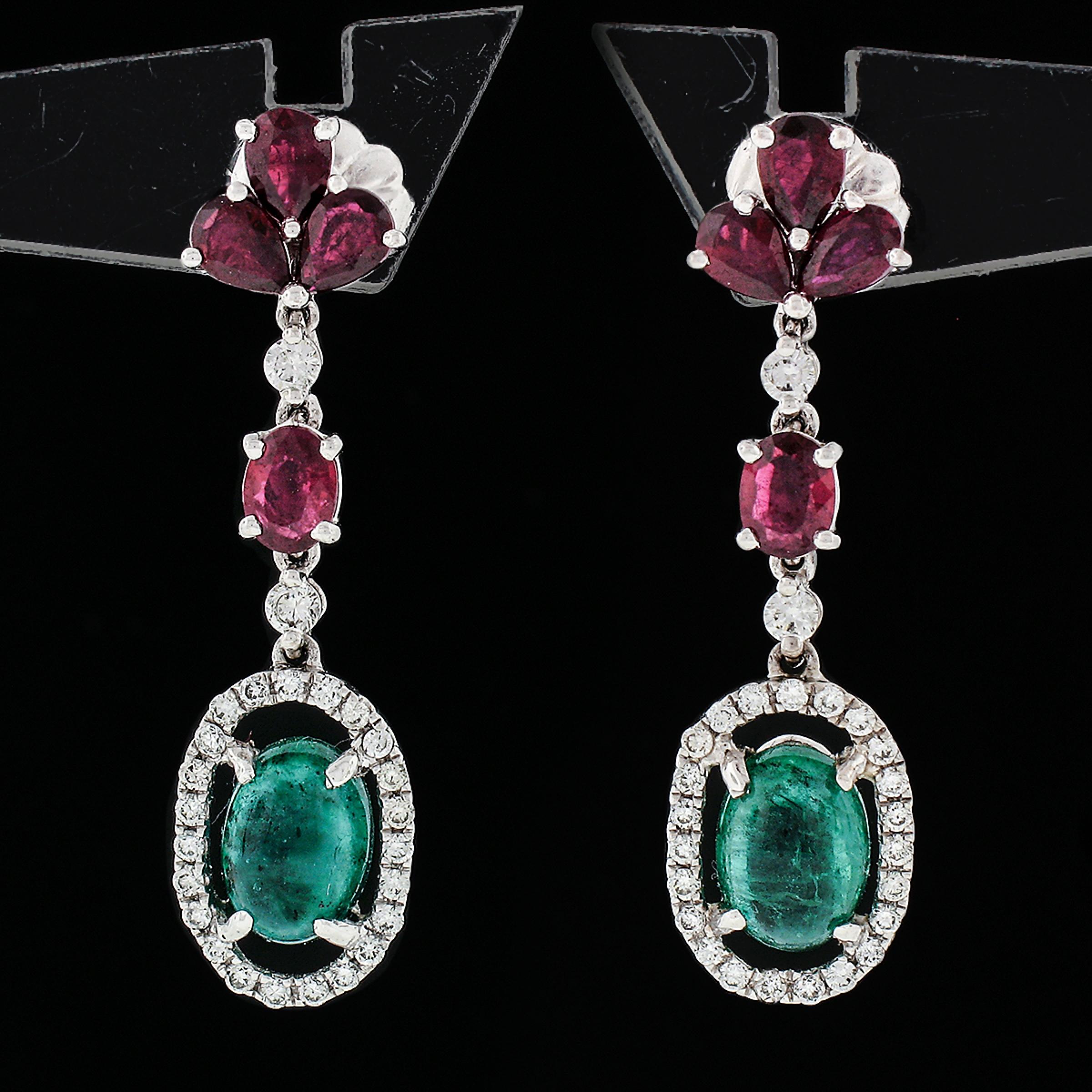You are looking at a very elegant pair of earrings crafted in solid 18k white gold and features a unique and fancy dangle design, set with excellent quality stones throughout. Each earring consists of a halo design that carries a gorgeous oval