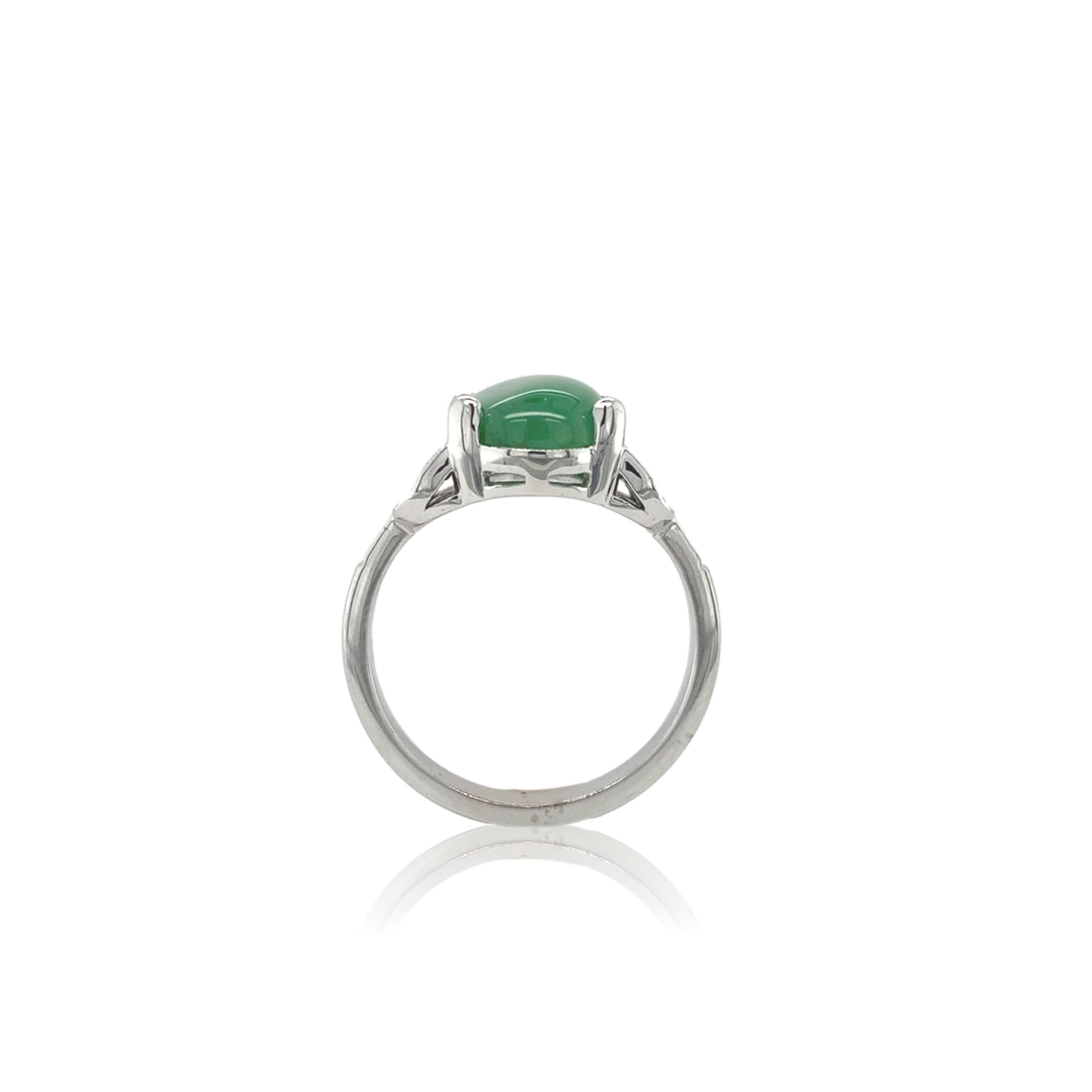 18k white gold ring featuring a natural green jadeite jade weighing 4.17 carats.  The jade has a GIA report #2235070633 stating natural color. The jade is a oval cabochon cut with even medium green color.  The jade measures 12.27mm x 8.42mm x