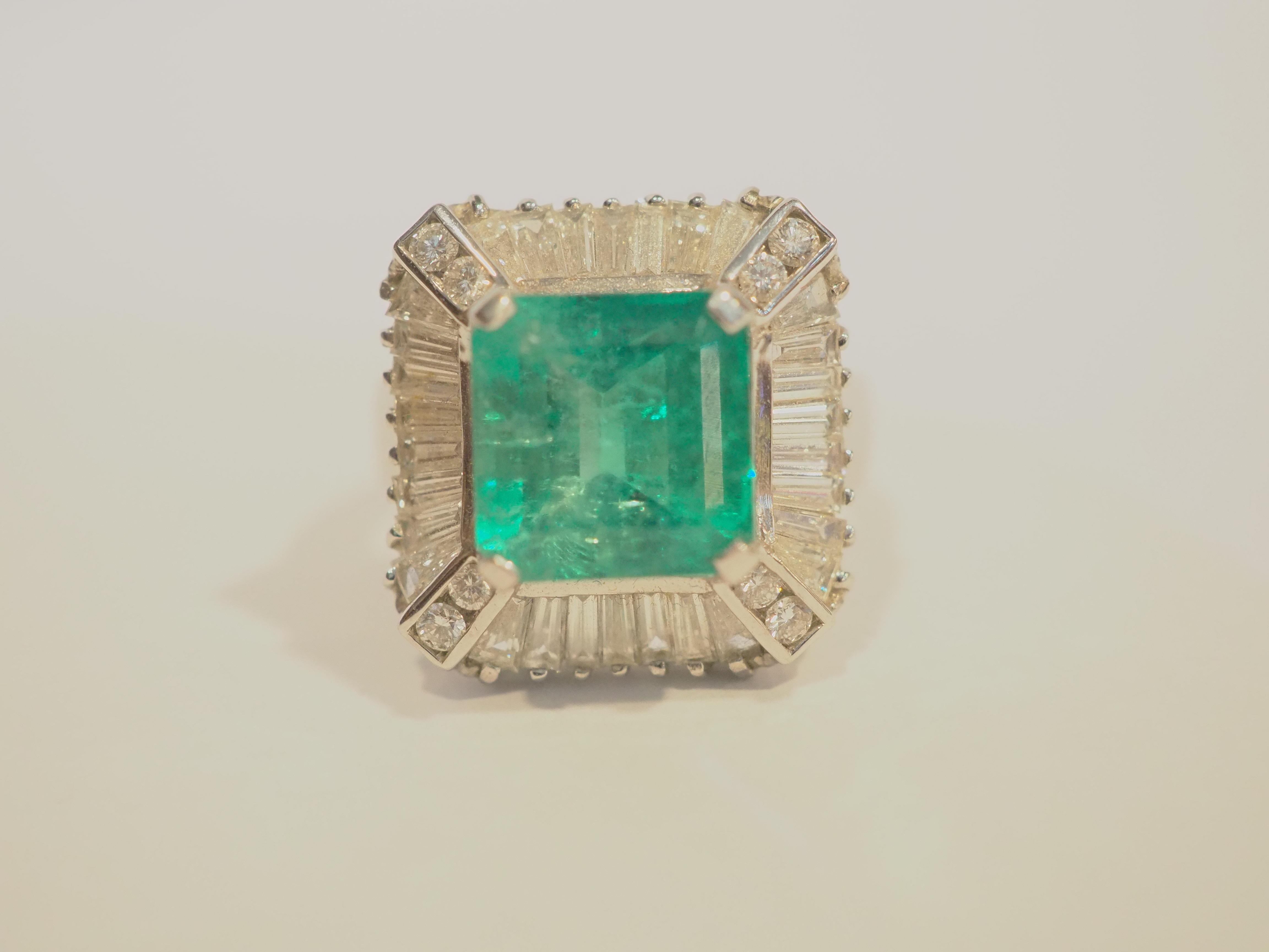  This beautiful cocktail ring boasts a spectacular and good quality emerald cut Colombian emerald! The diamonds are bright and lively and clarity and color all surrounding the beautiful leaf green gemstone. This ring is never worn and kept as like