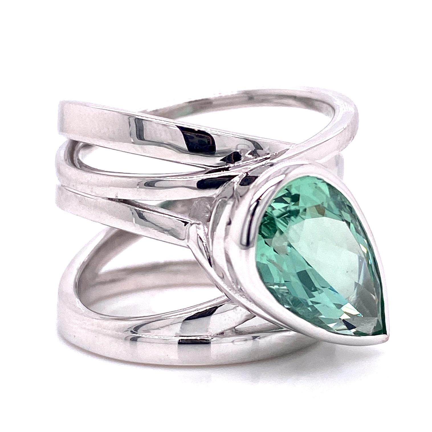 An 18k white gold wrap style ring bezel set with one 4.88 carat pear shaped green beryl. This ring was made and designed by llyn strong.
