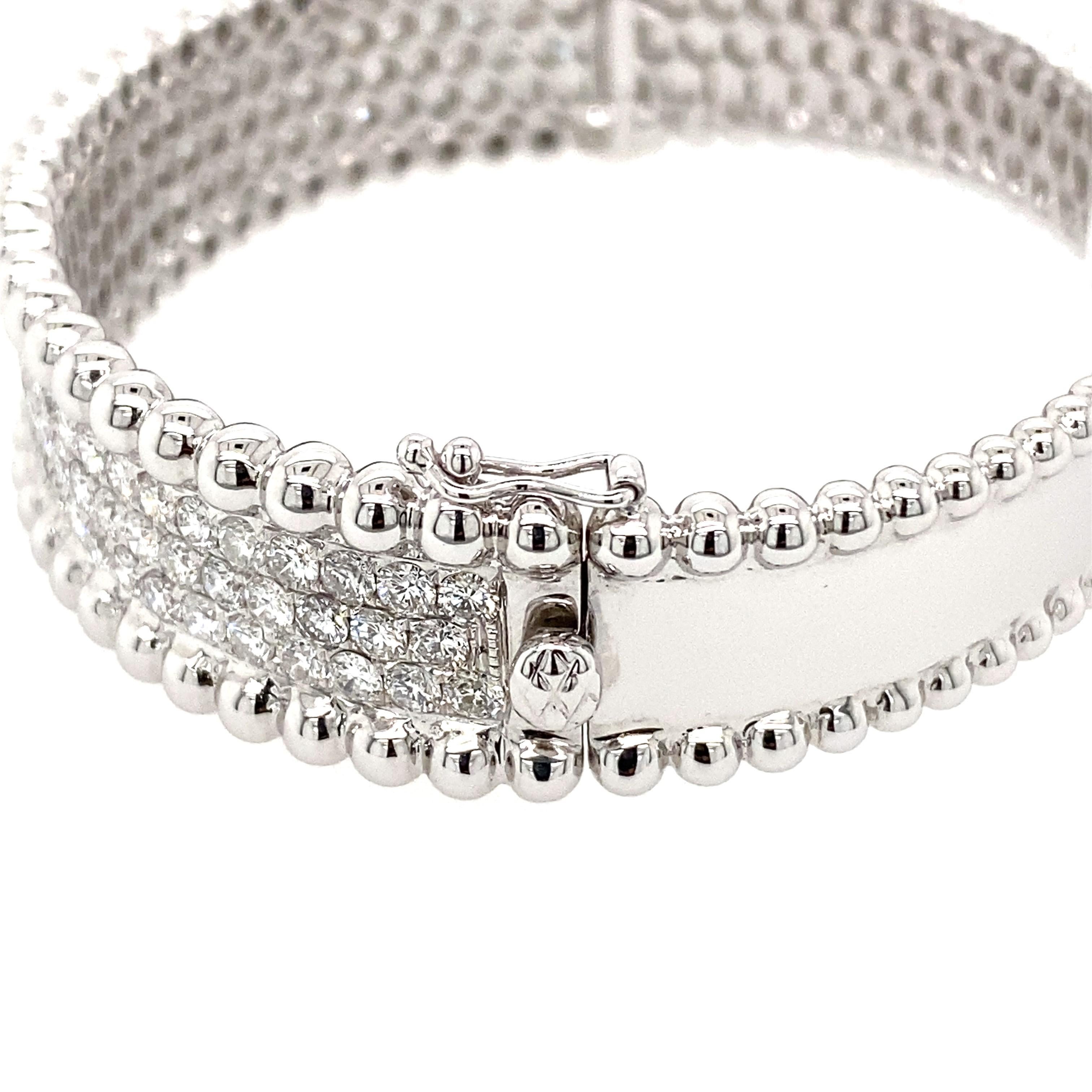 Oval Shaped 3 row Pave diamond hinged bangle with  beading on the top and bottom of the diamonds. 
Medium size, will fit an average size wrist - 6-6 3/4 inches. 
Safety clasp 

105 round brilliant diamonds 4.91 Carat total weight  
F-G/ VS-SI 
12 mm