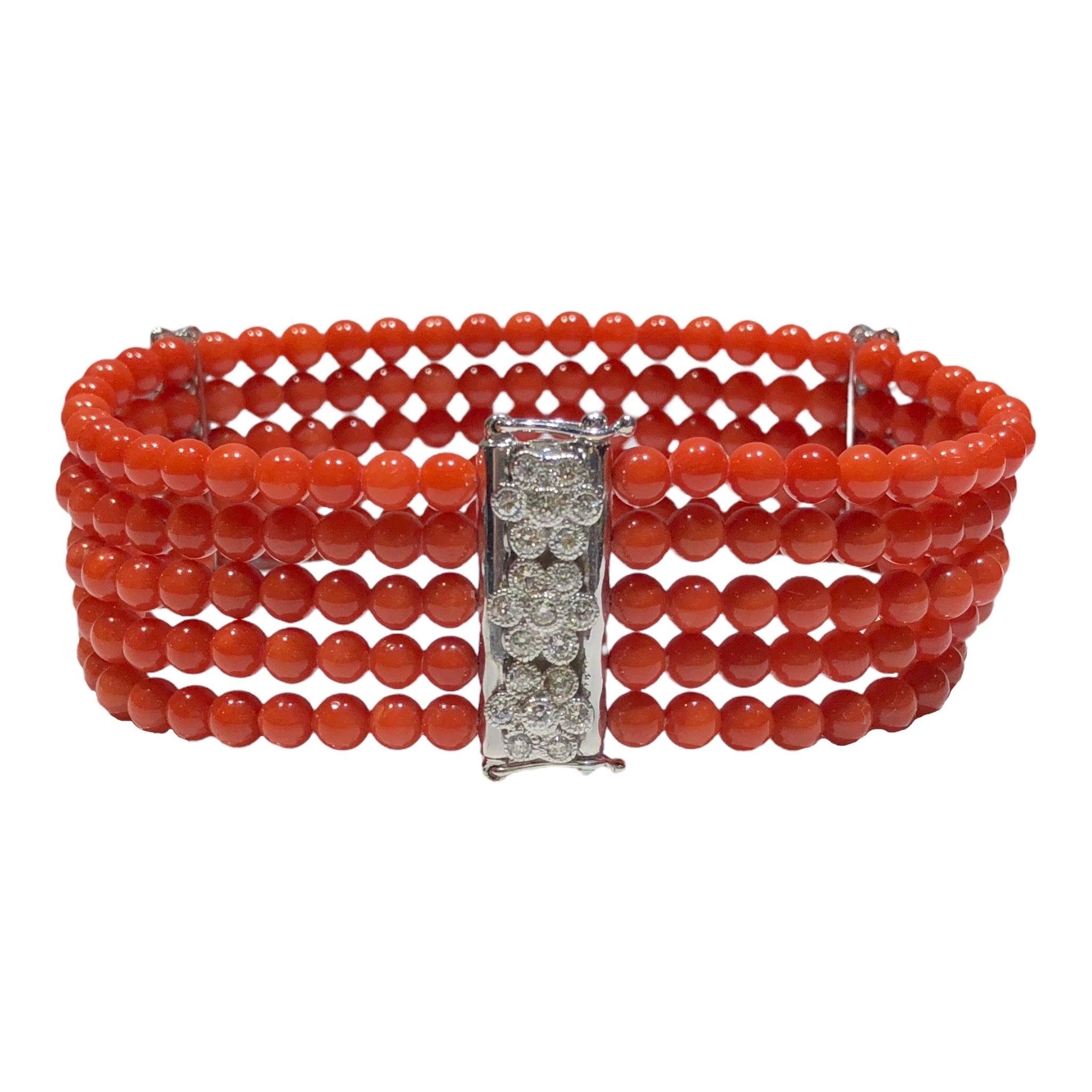 The bracelet features a five-strand design of 4 mm round natural coral beads with 18K white gold diamond florets spacers and clasp. Slide clasp with double safety. 
63 round brilliant cut diamonds: 1.30ctw. Color: G-H, Clarity: