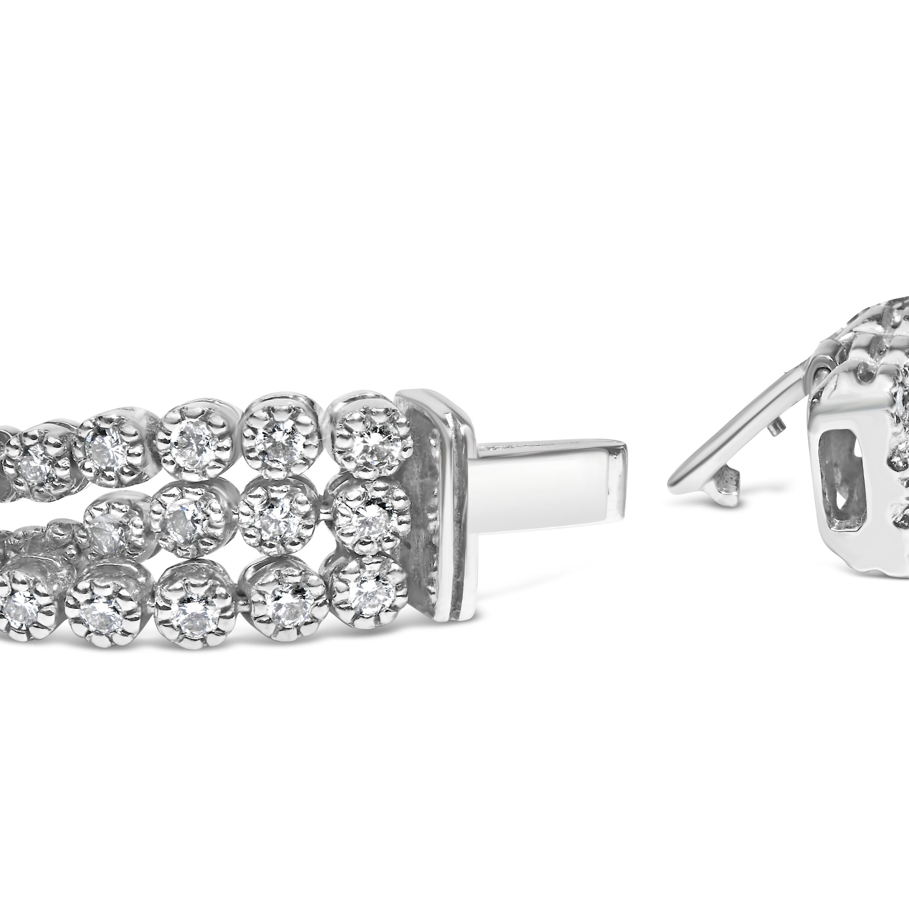 Indulge in the opulence of this breathtaking tennis bracelet, a masterpiece meticulously crafted from rhodium-plated 18K white gold. Every detail of this resplendent piece conveys luxury, from the triple rows of scintillating round cut diamonds to