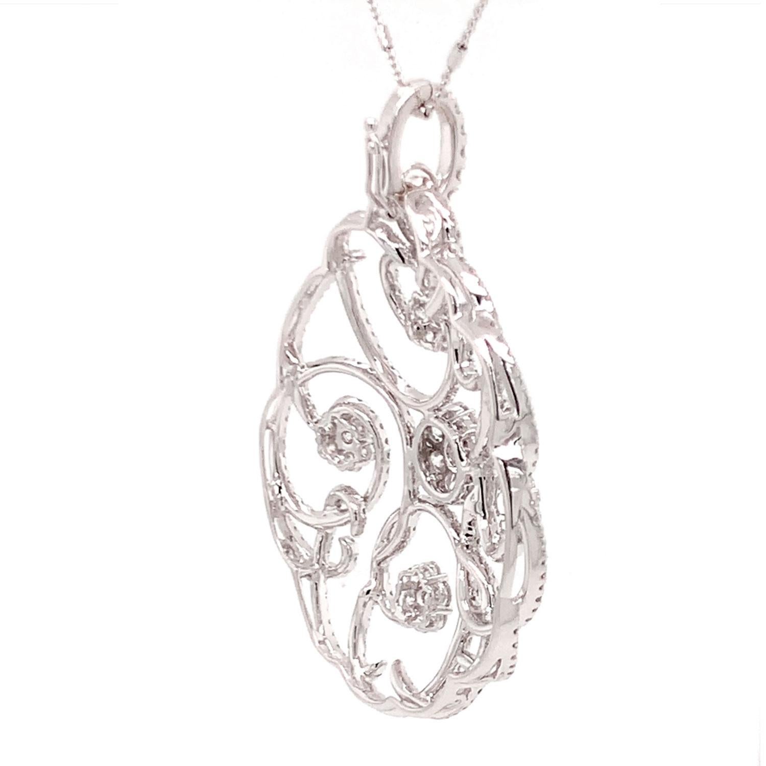 This stunning necklace/pendant features a 5.02 -Carat of brilliant round diamonds set in a nature-inspired floral design. The diamonds are F in Color and VS2-VS1 in Clarity. It measures 63 MM in length ( 2.4 Inches ) and 40 MM in width ( 1.6 inches)