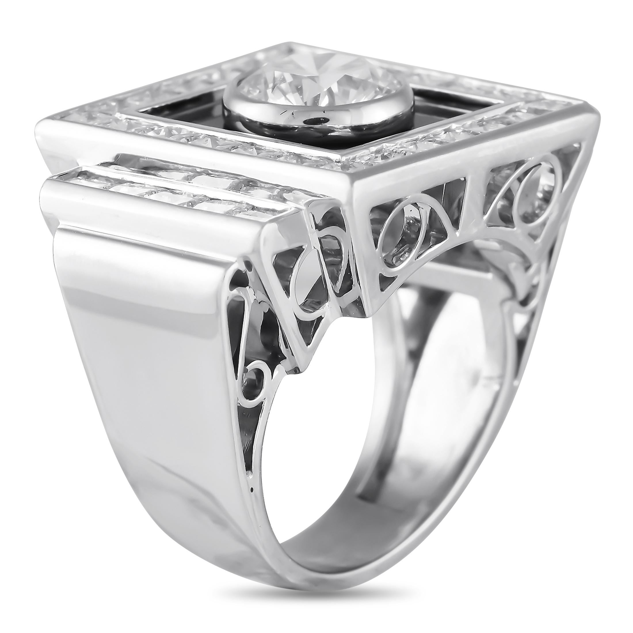 This vintage ring features an intricate 18K White Gold setting that is filled with dynamic details. A black Onyx gemstone seemingly enhances the sparkle of the 1.71 carat Diamond center stone. Additional Diamonds with a total weight of 3.57 carats