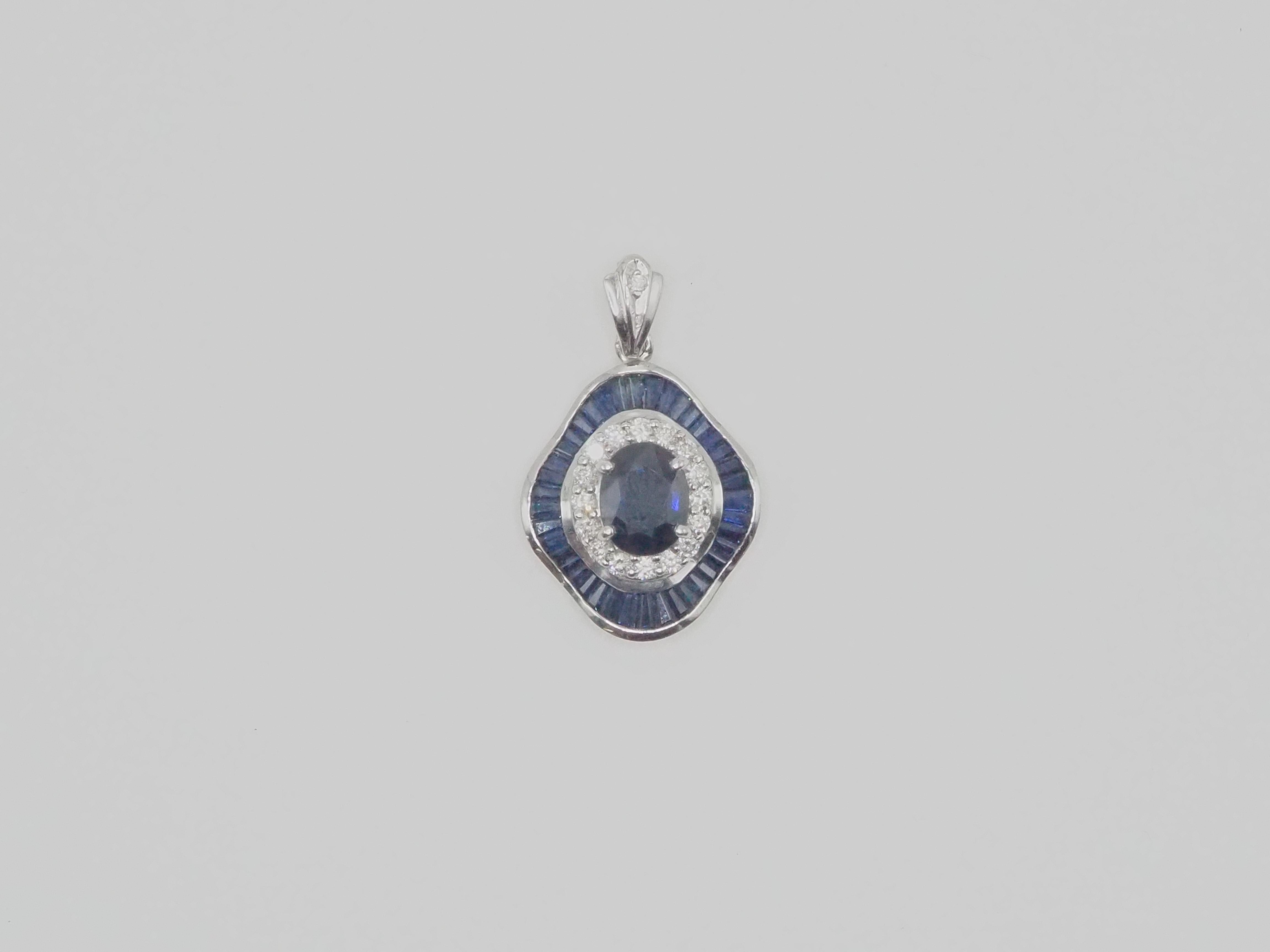 *Chain is not included*
A beautiful and quality cocktail pendant enhancer. This beautiful piece is crafted using 18K solid white gold. The piece is adorned with gorgeous oval and calibrated cut well- saturated blue sapphire and with 0.43 carats of