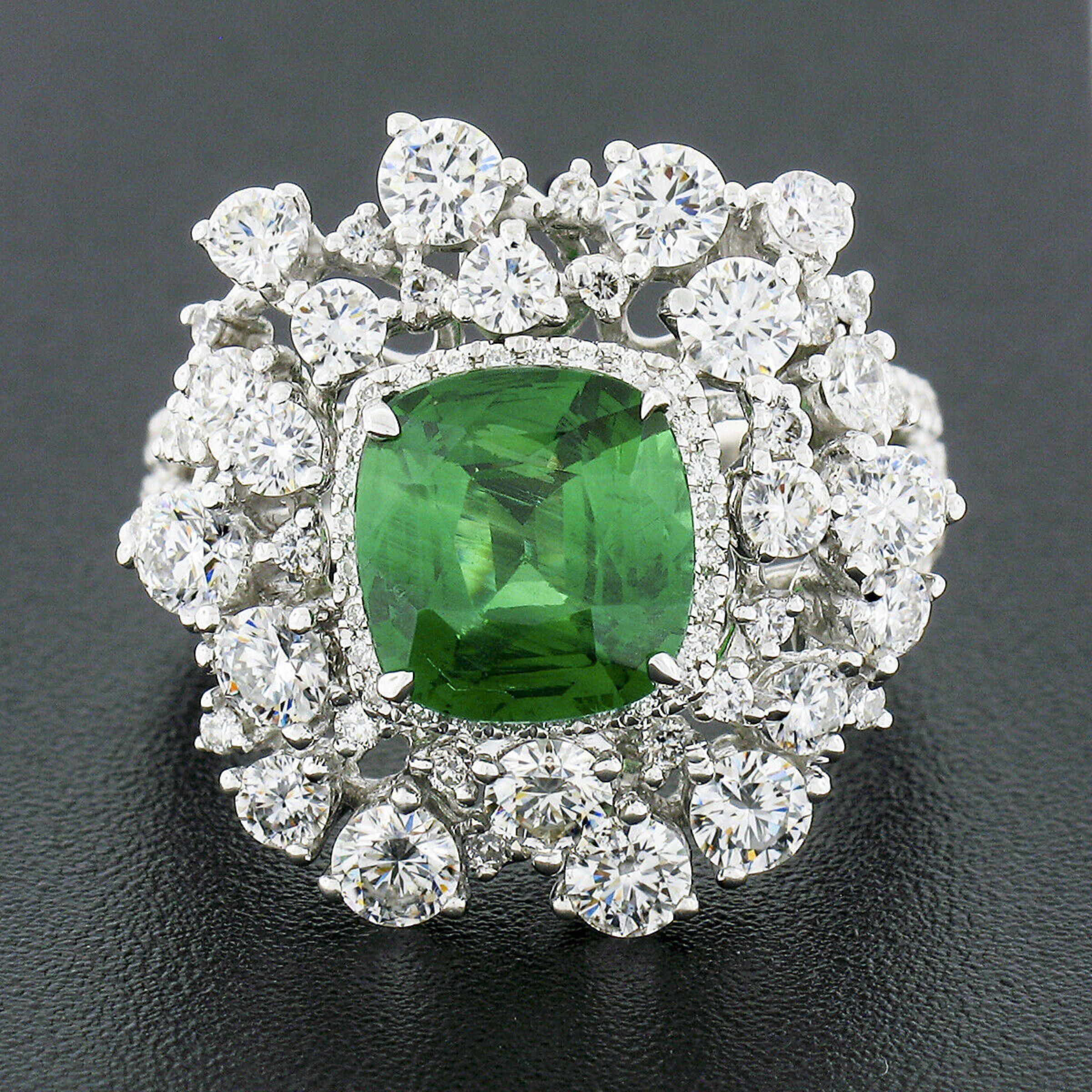 This gorgeous statement ring is very well crafted in solid 18k white gold and features a fine quality cushion cut tsavorite stone with an incredible fiery green color, certified by GIA and weighing 2.64 carats. The tsavorite is prong set at the