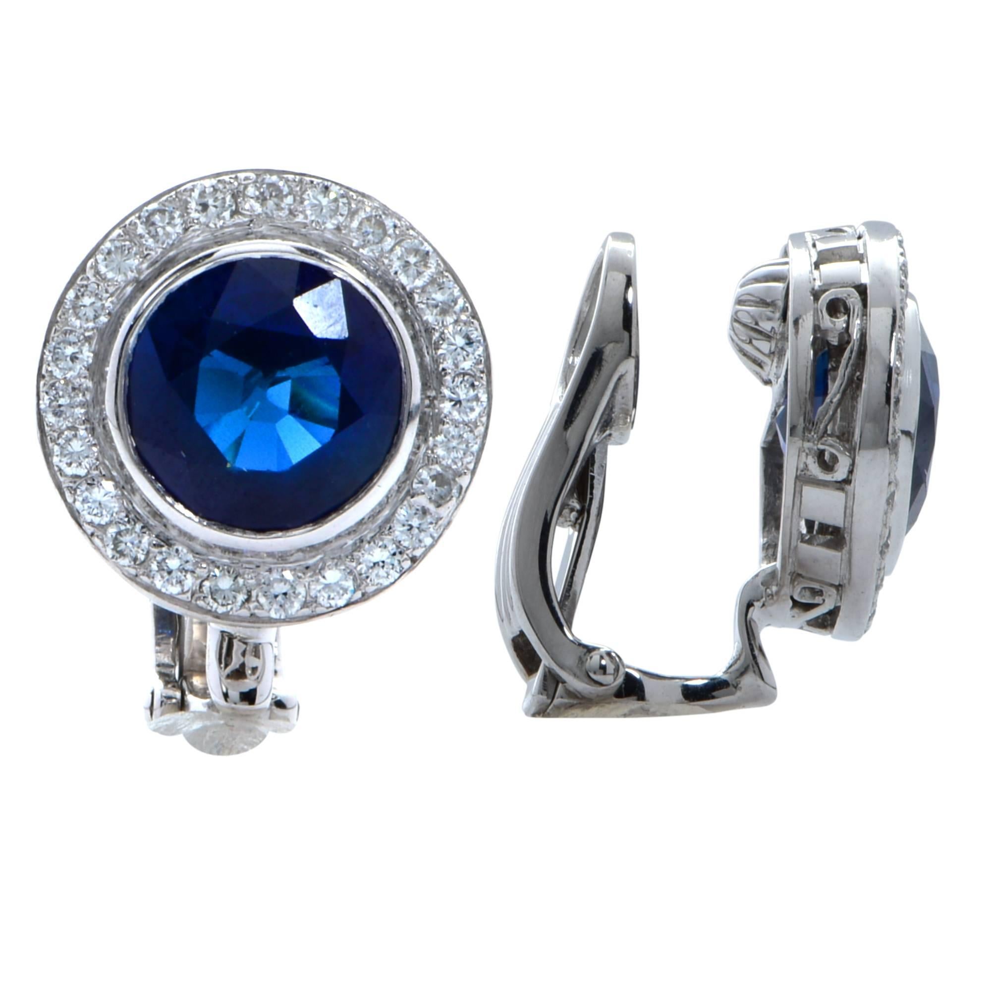 18k white gold halo earrings featuring 2 round cut sapphires weighing approximately 4.5cts total accented by 44 round brilliant cut diamonds weighing approximately .50cts total G color VS clarity.   


Our pieces are all accompanied by an appraisal
