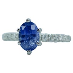 18 Karat White Gold 6 Prong Oval Ceylon Sapphire with Round White Diamond Ring
