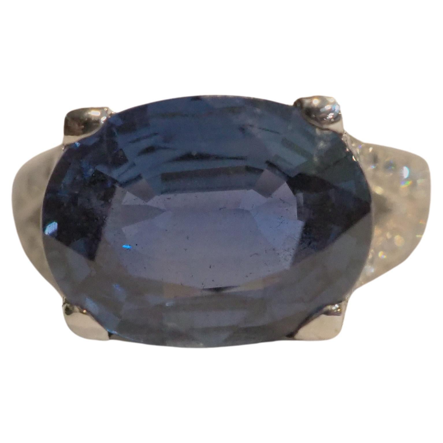 This beautiful cocktail split shank ring boasts a very stunning eye clean blue sapphire of decent size! The sapphire is an oval cut and is very clear with good saturation of blue color. Very rare sapphire color. There are 84 round melee diamonds
