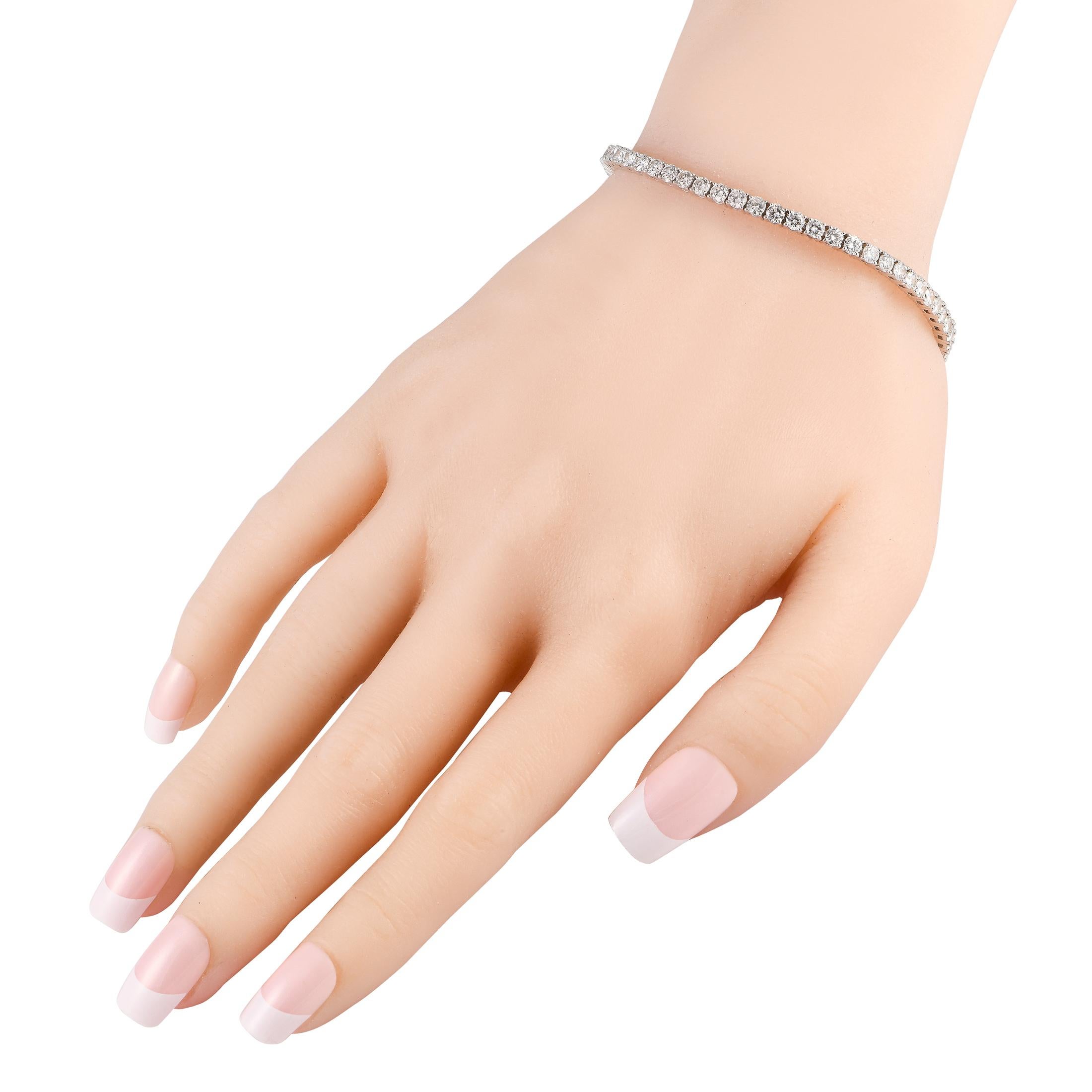 A classic and chic wrist adornment shining bright with 6.07 carats of diamonds. This tennis bracelet measures 7.5 inches long and has a box tab closure. This 18K White Gold 6.07ct Diamond Tennis Bracelet is presented in a gift box.
