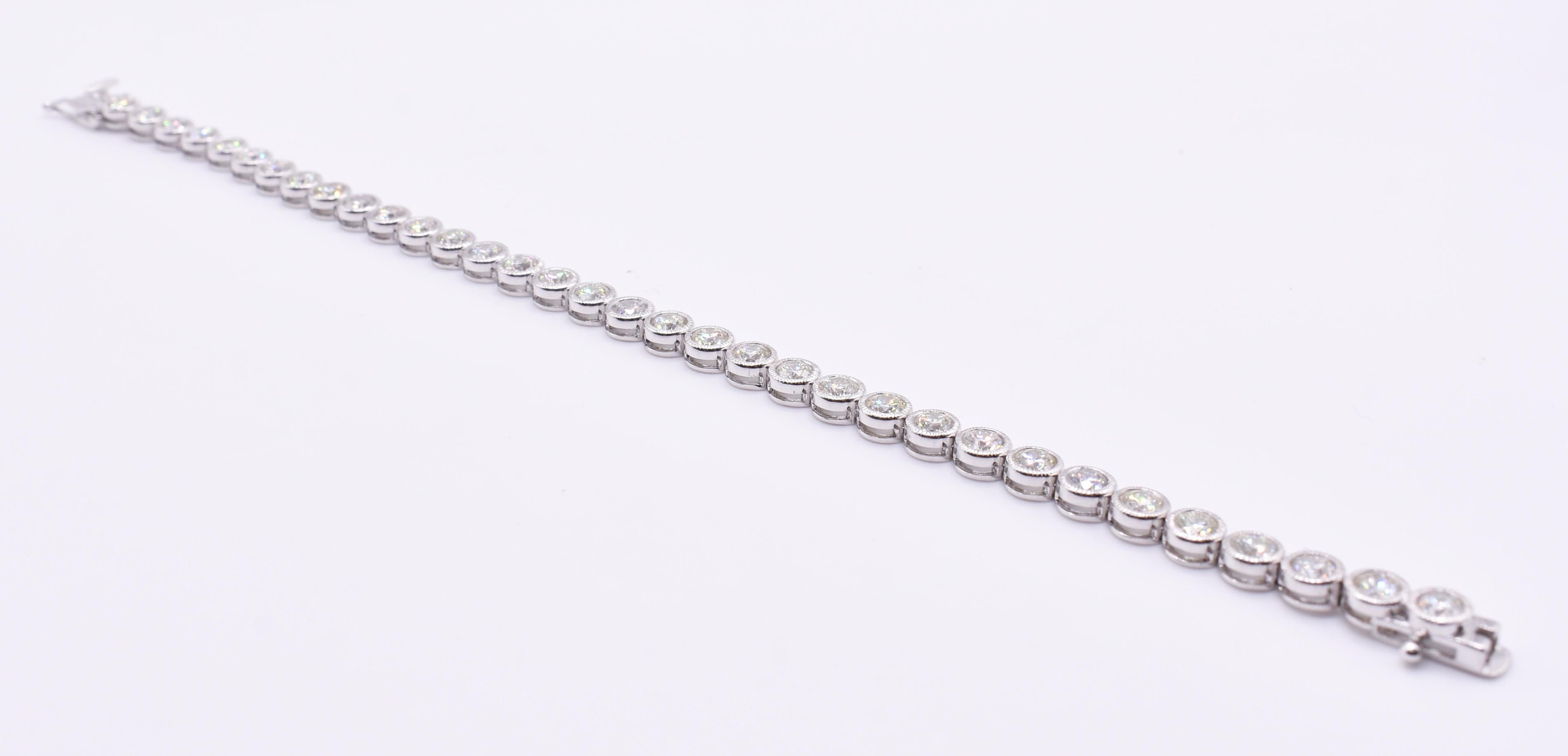 For sale is a fine 18k white gold 6.62ct diamond tennis bracelet, 34 diamonds in a rub over miligrain setting, individually hinged with a box and tongue clasp. 

Metal: 18k White Gold
Total Carat Weight: 6.62ct
Clarity: SI/VS
Colour: H/I
Gold