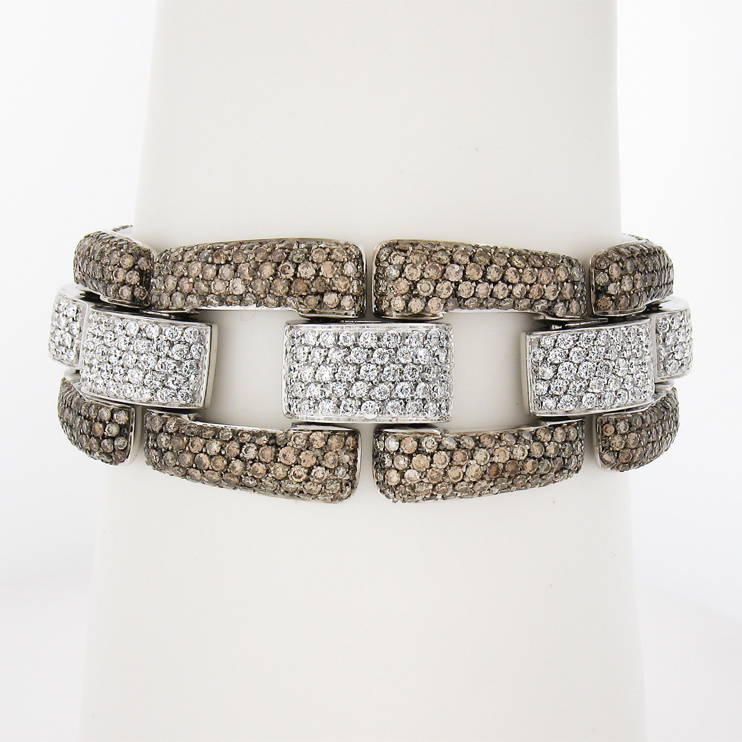 We hear bracelets being drenched in diamonds - this one is LITERALLY drenched in diamonds! Every part of this bracelet is covered in hand set pave round brilliant diamonds. The contrast between the white and fancy colored diamonds along with the