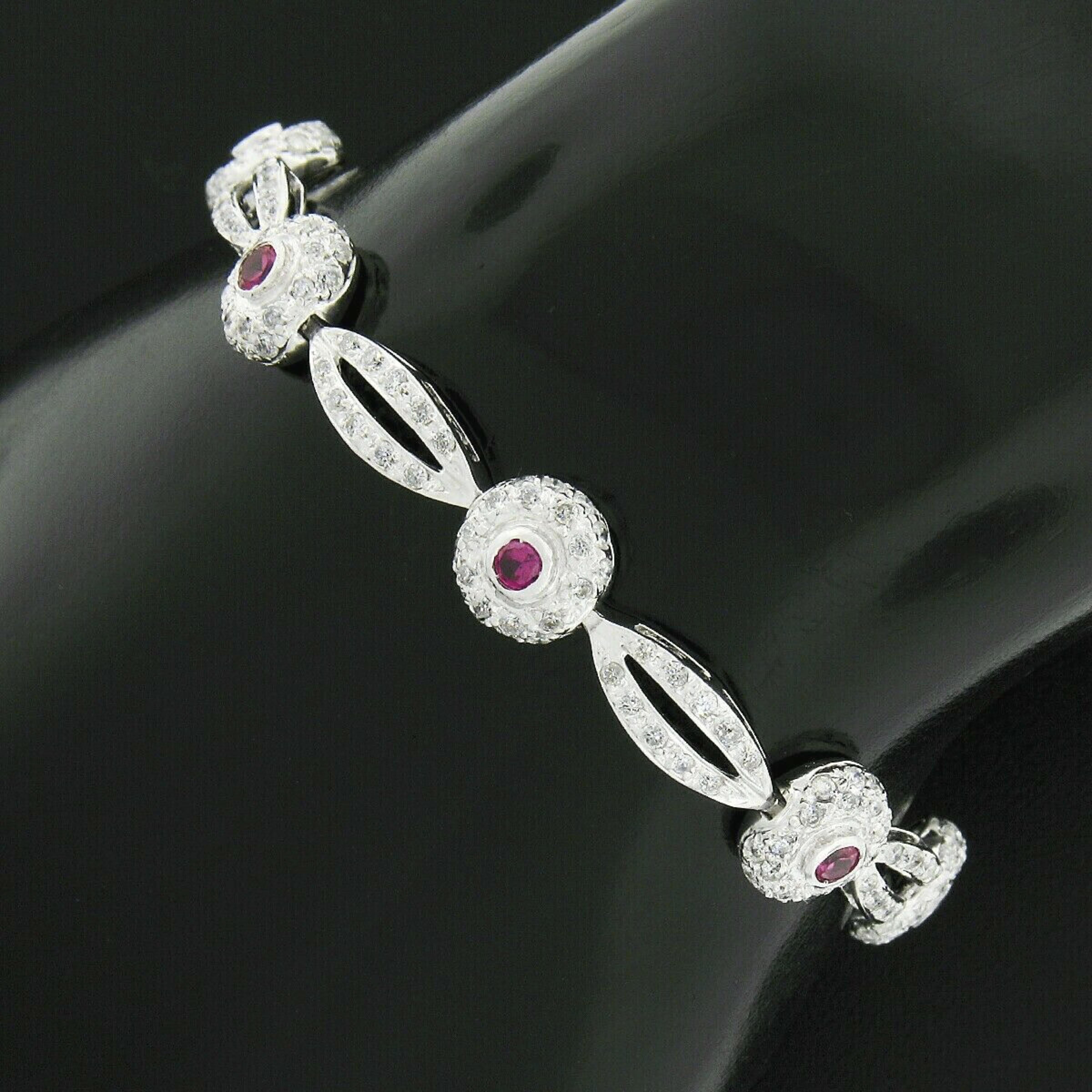 Here we have an absolutely breathtaking bracelet that is crafted in solid 18k white gold and completely drenched with fine quality diamonds with gorgeous ruby accents throughout. The round brilliant cut diamonds are neatly pave set throughout the