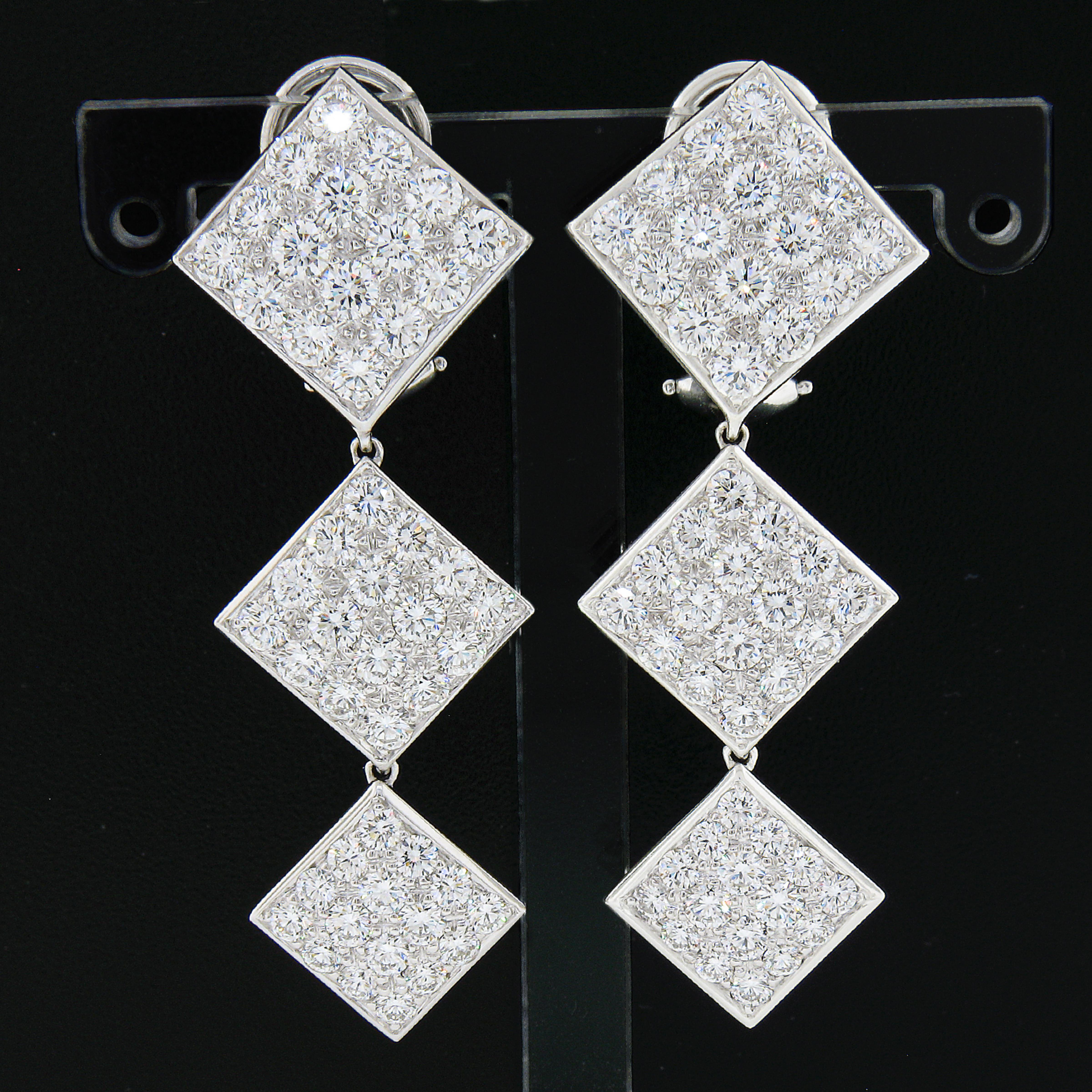 This breathtaking pair of statement diamond dangle earrings is crafted in solid 18k white gold and are drenched with approximately 6 carats of SUPER FINE quality round brilliant cut diamonds throughout. These diamonds are perfectly pave set