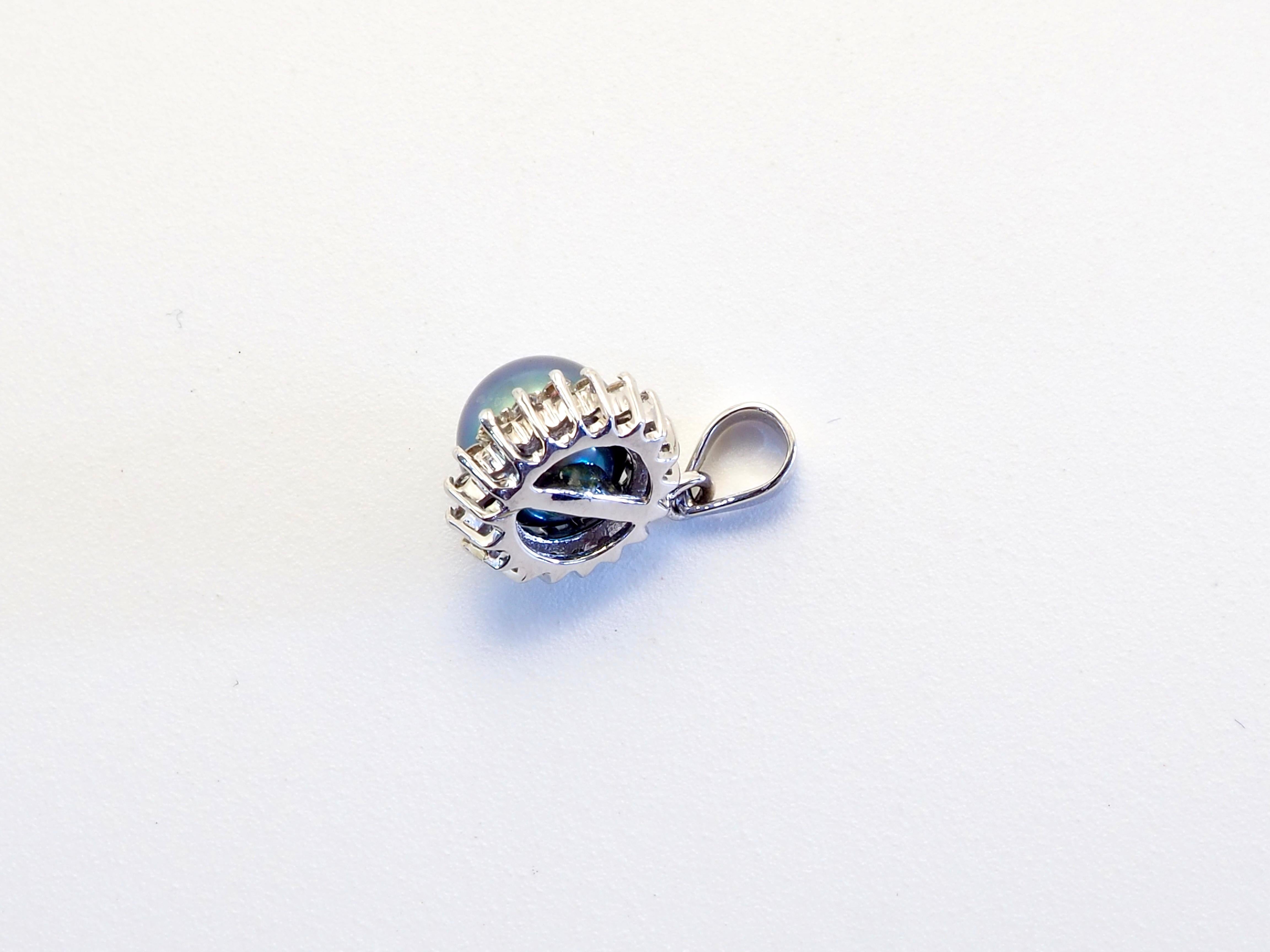 Marvelous artwork with starburst design. The Tahitian Pearl is lustrous rare greenish black and almost round with little blemishes present and the cluster of diamonds is made up of top color which shines brightly. A fine craftsmanship from bygone