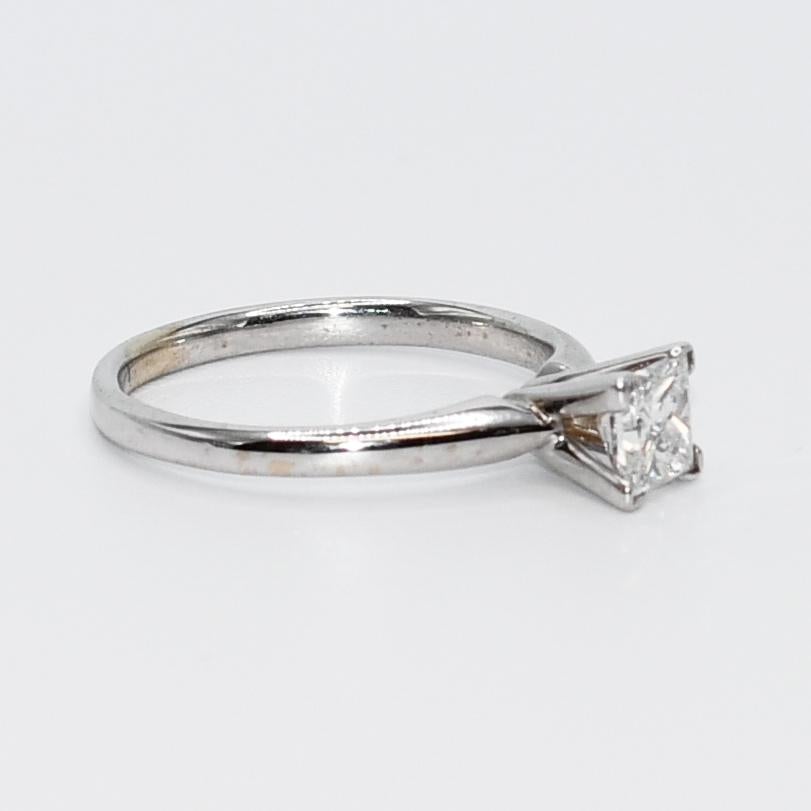18K White Gold .71ct Princess Cut Diamond Ring, 3.3g, GSL Cert.

Ladies princess cut diamond ring in 18k white gold.
Stamped 18k and weighs 3.3 grams.
The princess cut diamond weighs .71 carats, D color, i1 clarity, very good cut grade.
The diamond