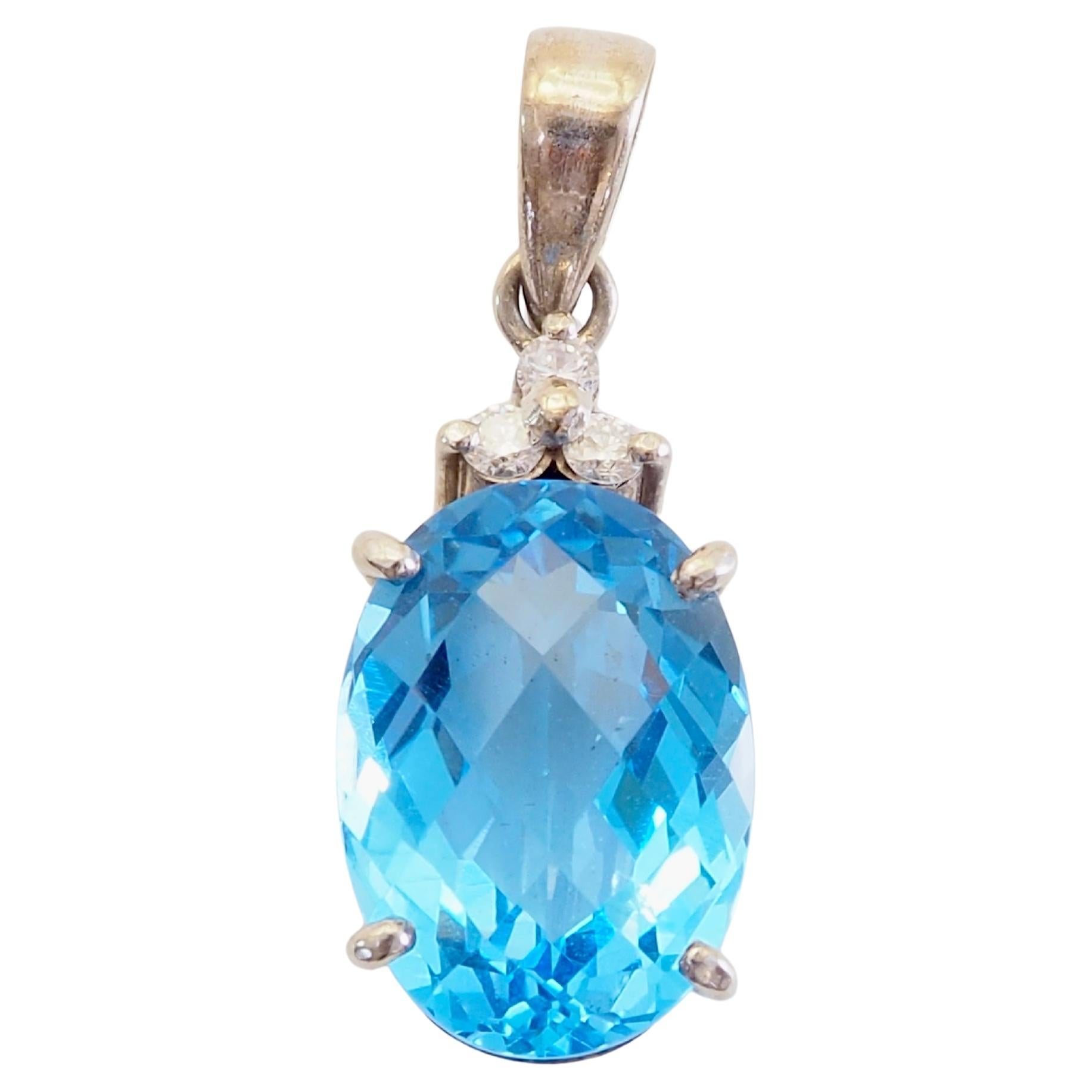 18K White Gold 7.67ct Oval Checker Blue Topaz 
0.12ct Diamond Pendant