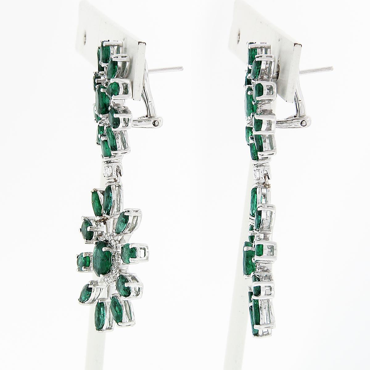 Here we have a gorgeous pair of drop dangle earrings crafted from solid 18k white gold featuring a spray snowflake design with 100% natural emeralds and diamonds. The emeralds, weighing approximately 7.80ctw, vary in shape including oval, marquise,