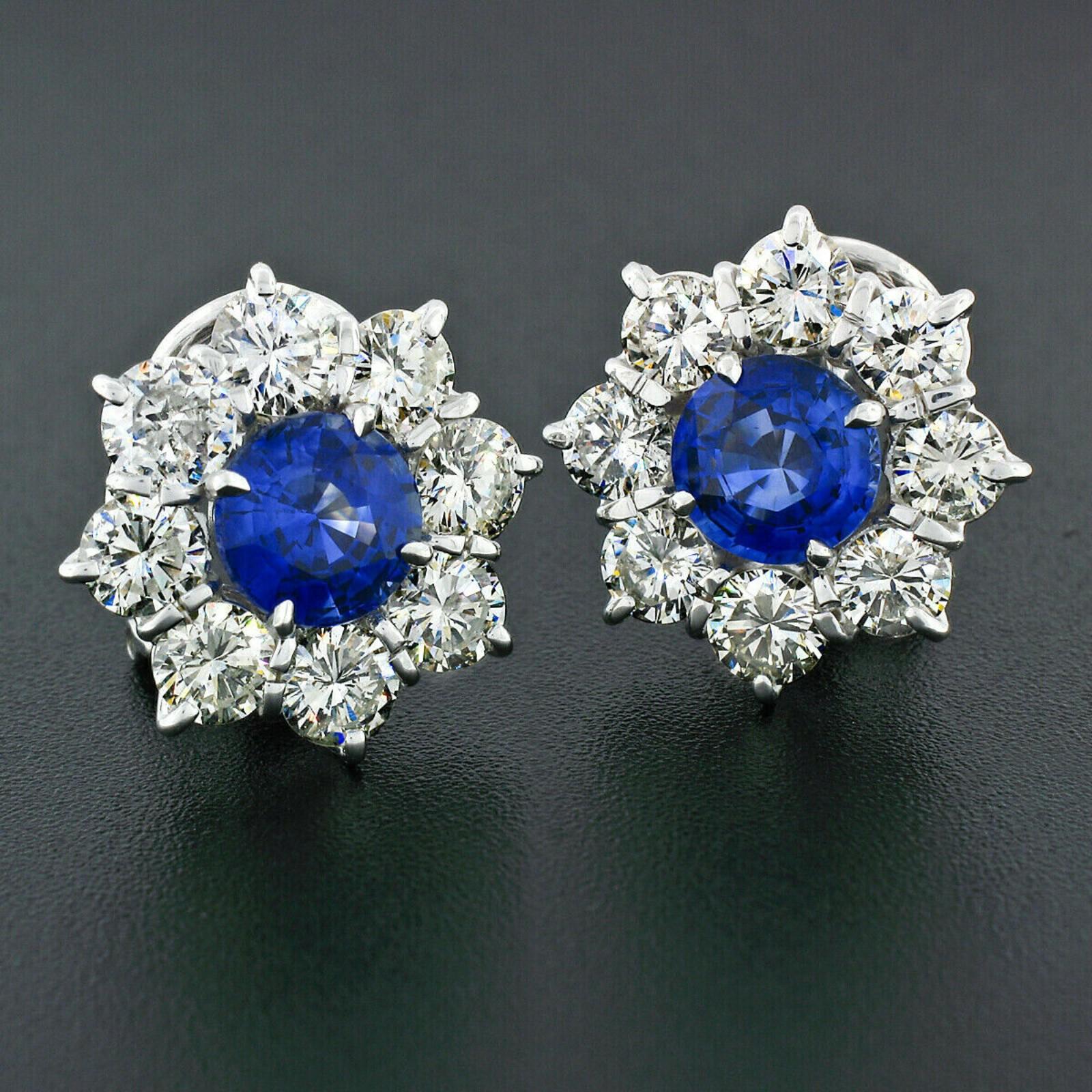 This is an absolutely gorgeous pair of sapphire and diamond cluster flower earrings, very well crafted in solid 18k white gold. Each earring is prong set with a very fine quality, round brilliant cut sapphire at its center. The GIA certified