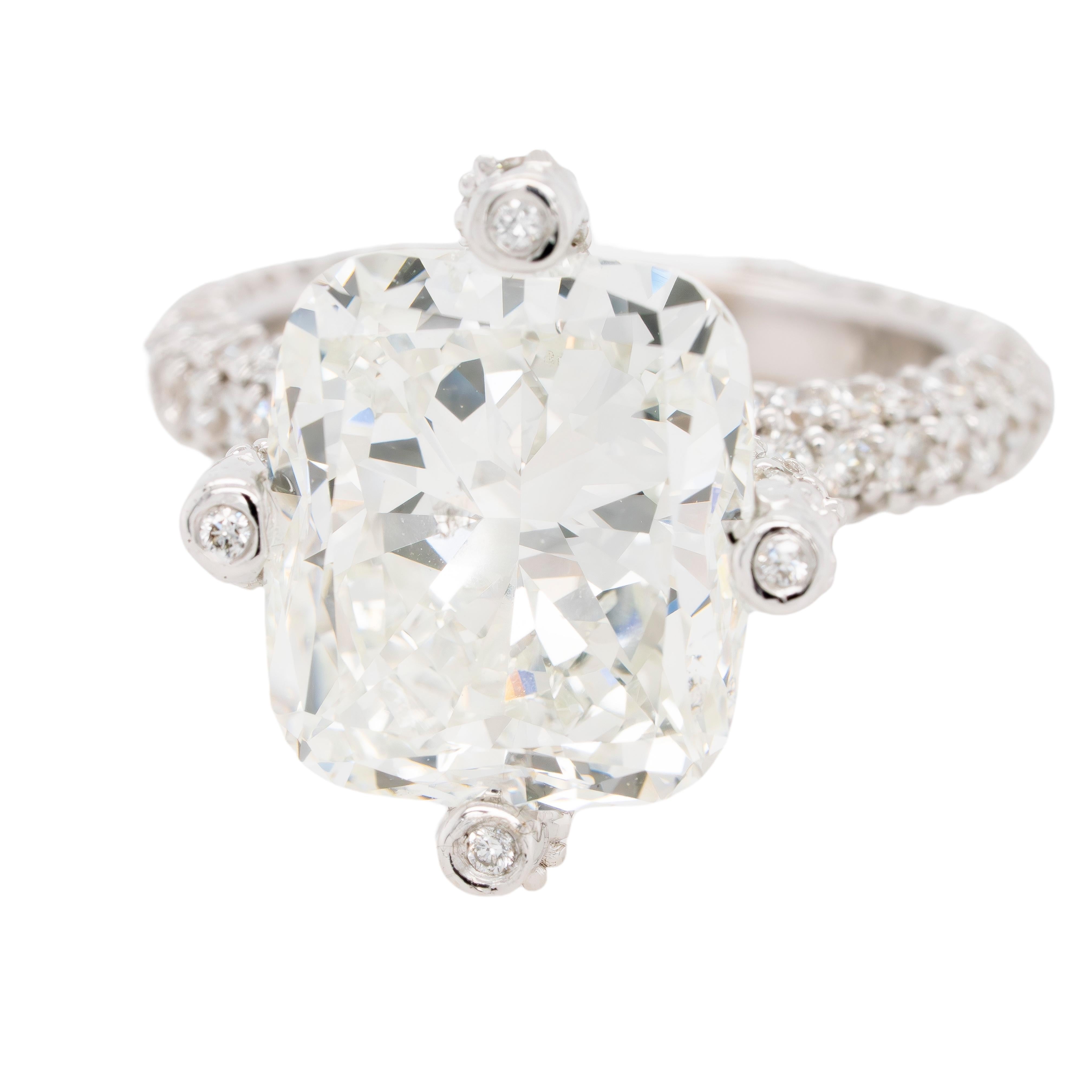 This breathtaking 18k white gold engagement ring features an impressive 8.62-carat natural cushion-cut diamond. Certified by GIA (Report # 2225138219), the center diamond boasts a J color and SI2 clarity, offering remarkable brilliance and timeless