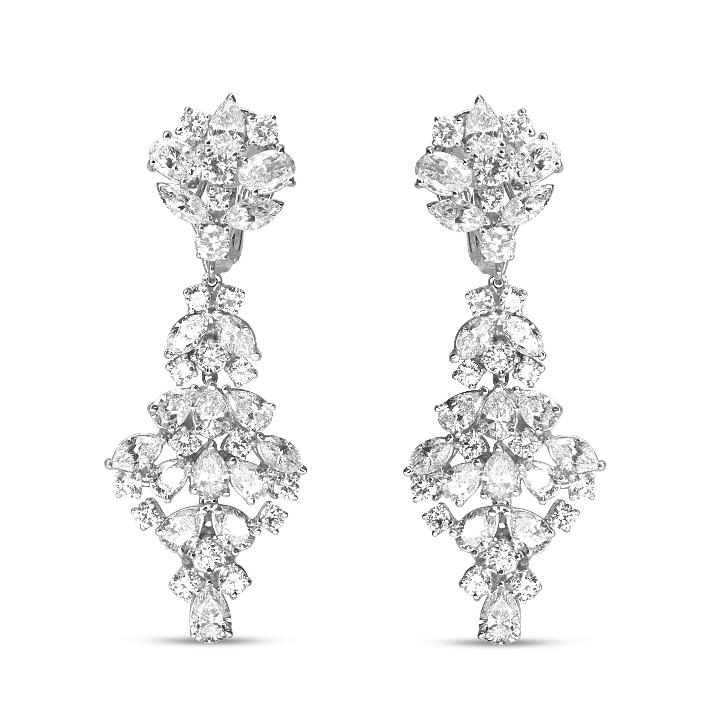 Brimming with the vivacious sparkle of natural, white diamonds, these dazzling drop earrings for her feature marquise, oval, pear, and round shaped diamonds in a prong-setting and arranged in a cluster design. These geometric-inspired cluster