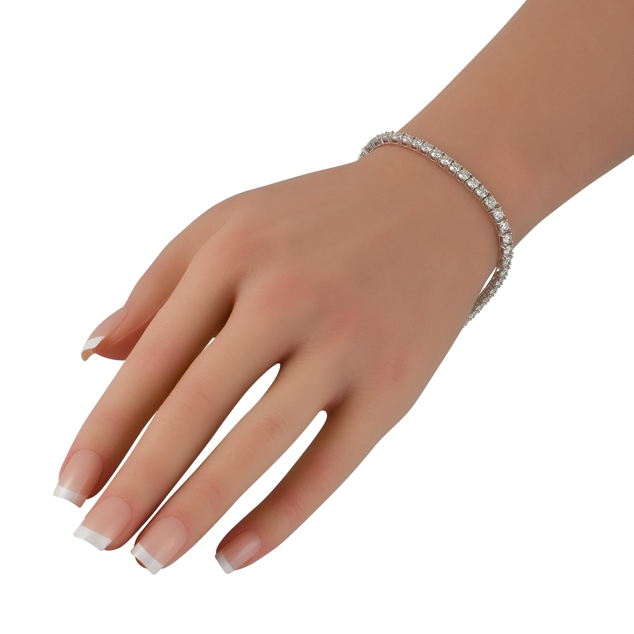This classically elegant tennis bracelet will instantly elevate any ensemble. Diamonds with a total weight of 9.03 carats sparkle brightly from their place within the 18K White Gold setting. A luxury piece that is ideal for everyday wear, it
