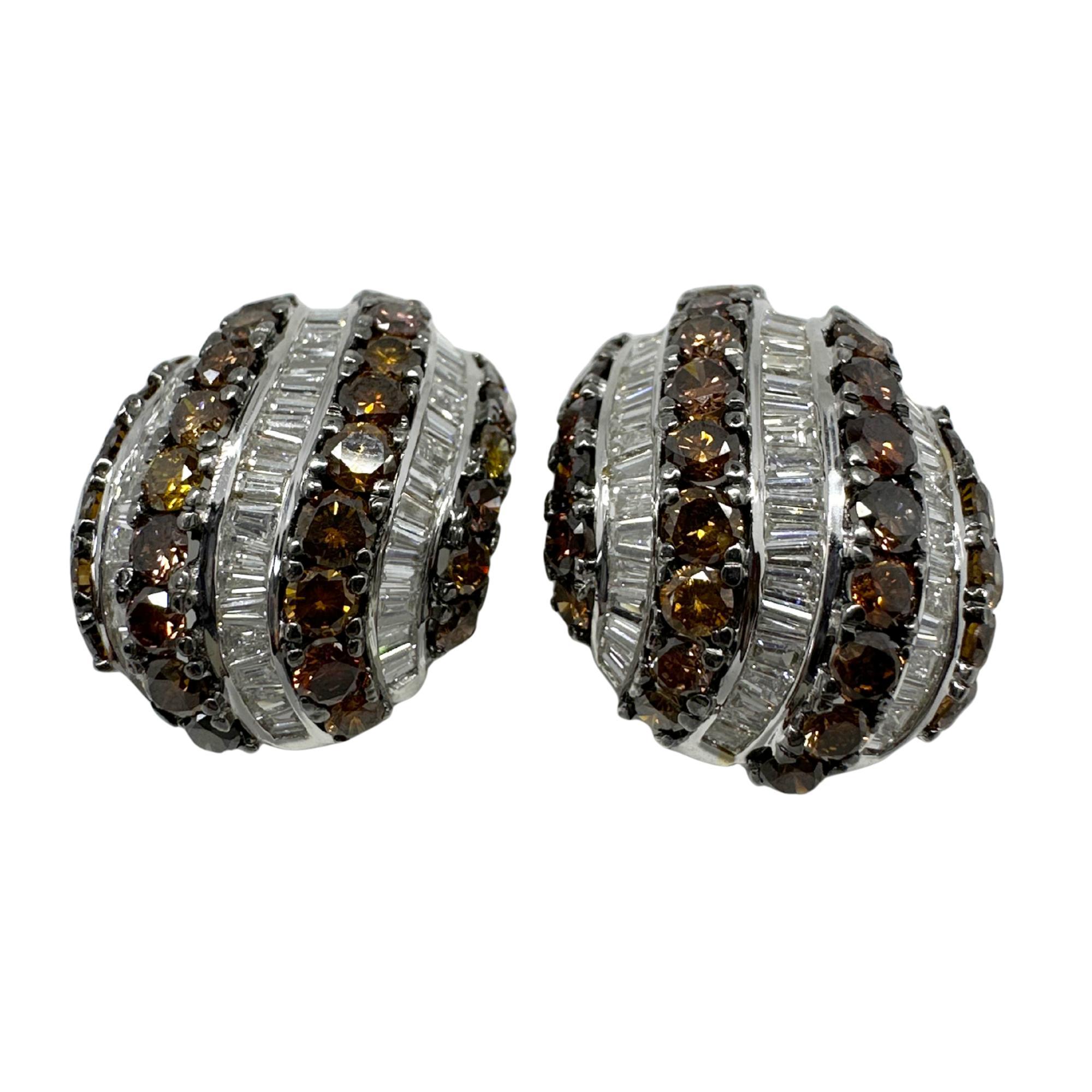 Make a bold statement with these vintage 18K white gold dome earrings, featuring 1.61 carats of tapered baguette cut white diamonds and richly hued round brown diamonds.

18K White Gold 9.31 Carat Tapered Baguette Cut White and Brown Diamond