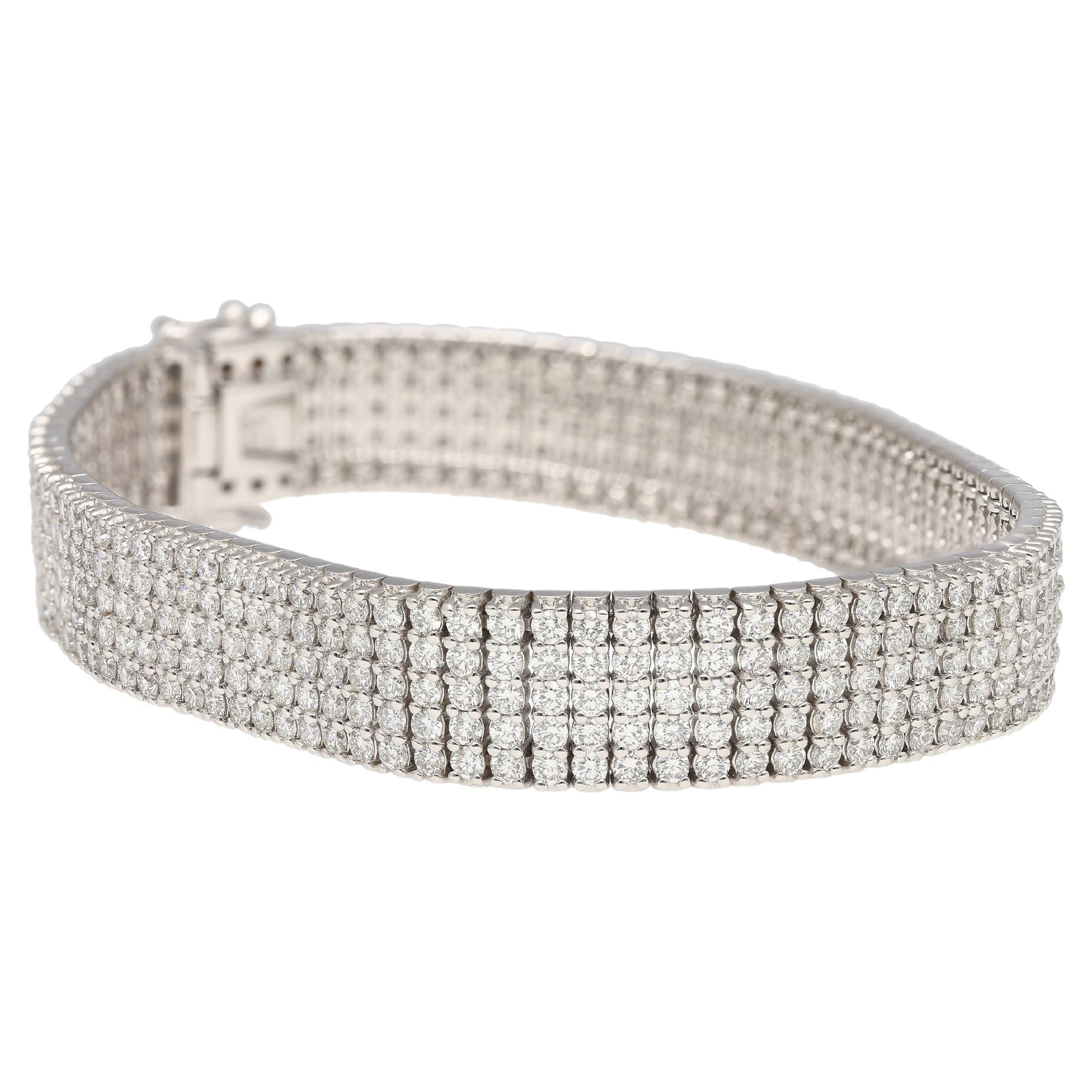 Crafted in 18K white gold and showcasing a total weight of 9.32 carats of round brilliant cut natural diamonds.

The bracelet features a secure box closure, ensuring peace of mind while adorning your wrist. Its good width provides a substantial