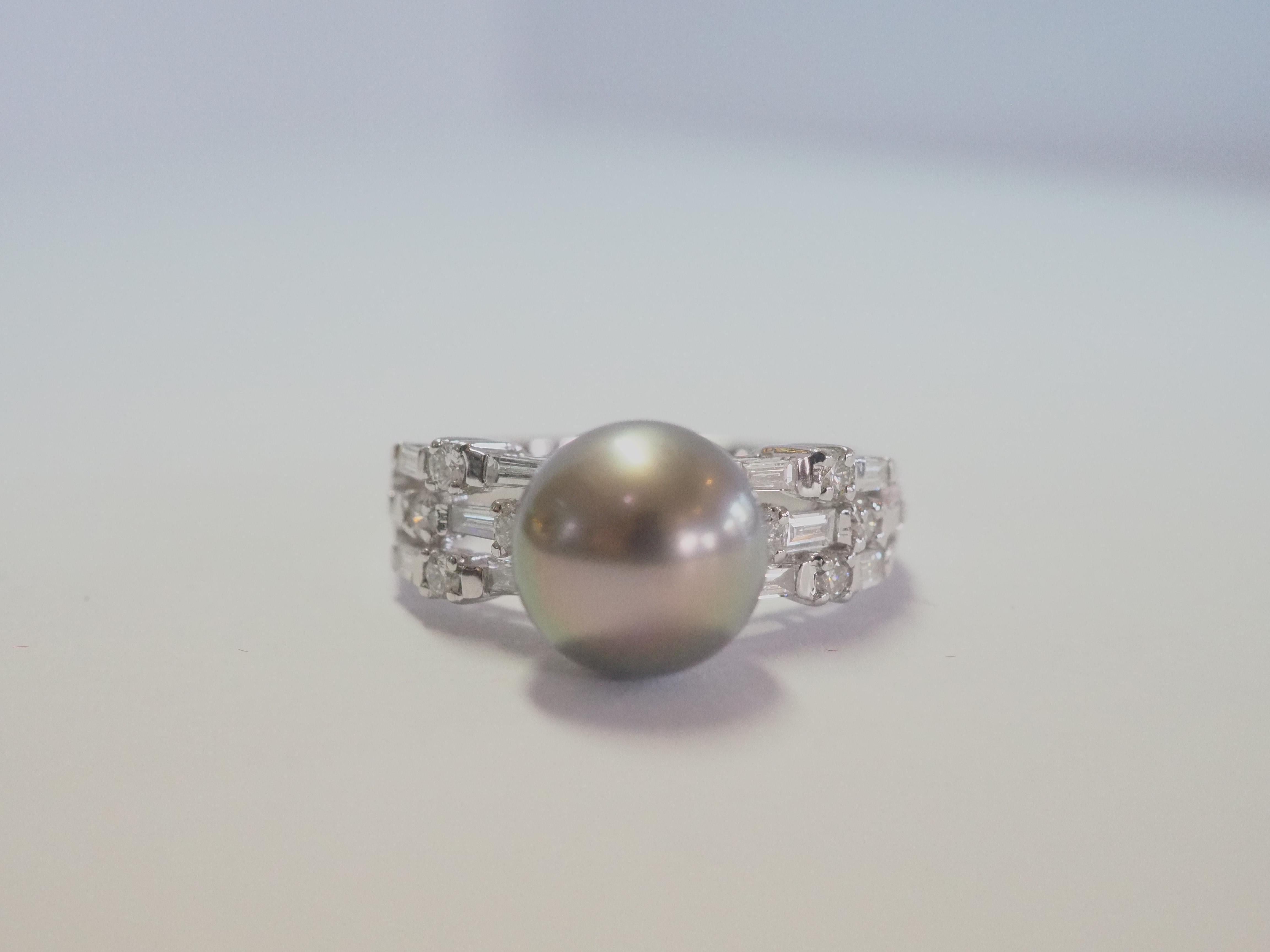 This brilliant 18k white gold ring is adorned with a rare and beautiful brownish green Tahiti pearl! The pearl is perfectly rounded and has little 1 or 2 blemishes or natural marks. The diameter of the pearl is 9mm. There are 12 baguette diamonds