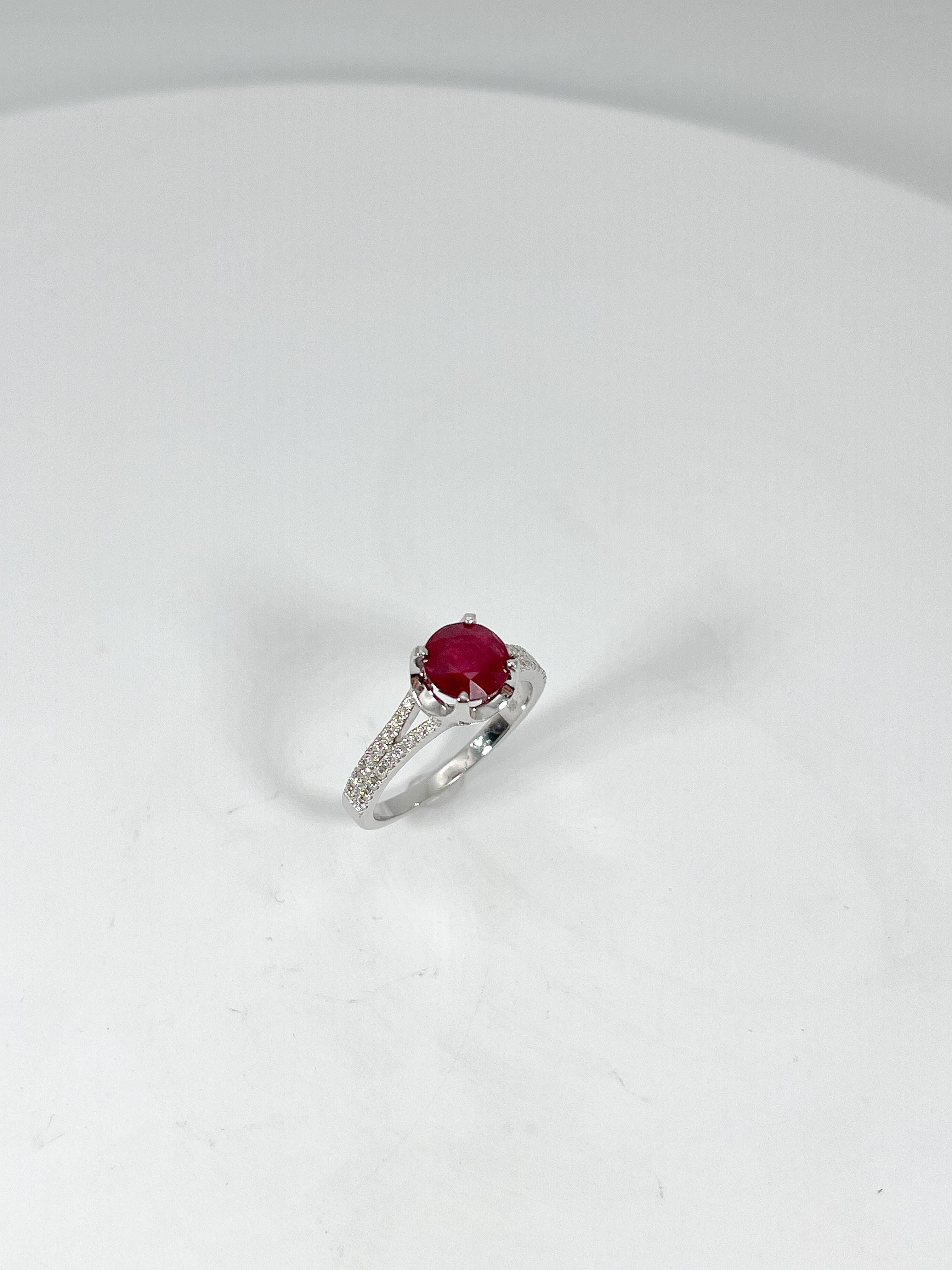 18k white gold allure split shank ring with a round 1.84 carat ruby center stone. Ring has round diamond .16 CTW side stones that go halfway down the shank. Ring is a size 6 1/4 and has a weigh of 3.9 grams.