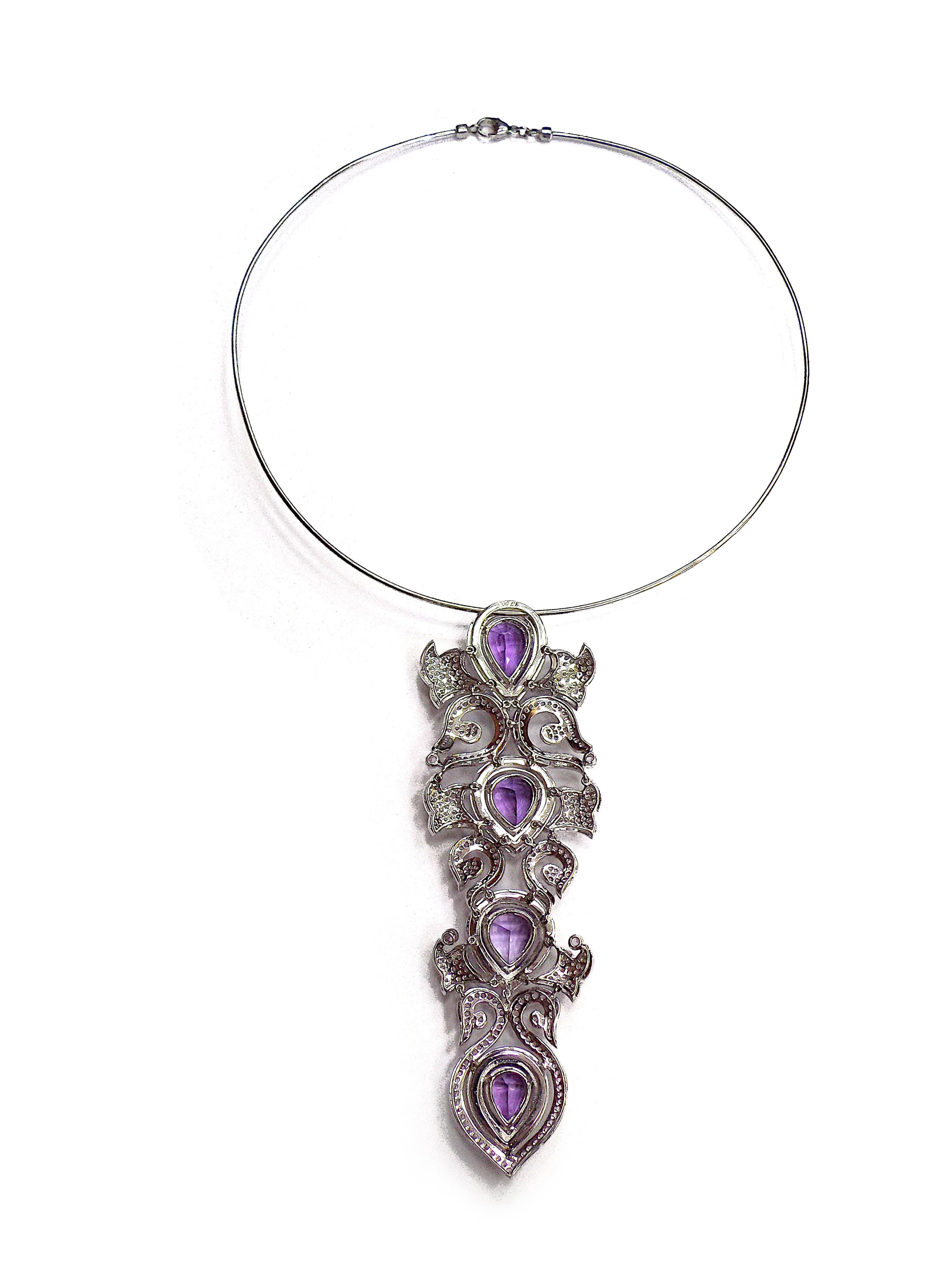 Consisting of a wire collar necklace suspending a motif pendant containing four pear shape mixed cut amethyst, numerous round mixed cut pink sapphires measuring 1.15-2.65 mm in diameter and numerous round brilliant cut diamonds weighing 8.00 carats