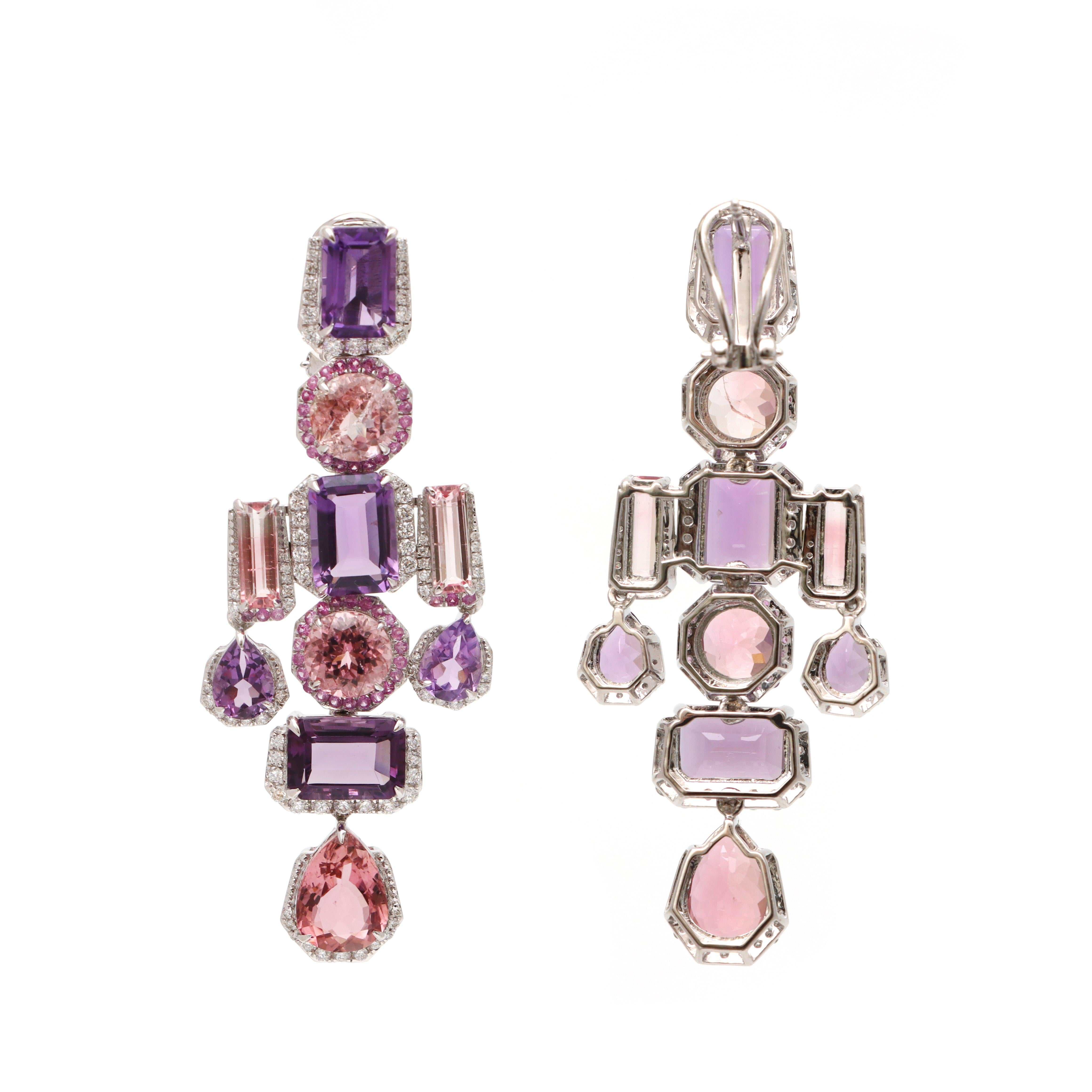 Embrace timeless elegance with these Amethyst Pink Sapphire And Tourmaline Hoop Earrings.

ITEM CODE - NFJSD -1771

METAL PURITY - 18K

GEMSTONE - Pink sapphire Tourmaline And Amethyst

TOTAL GEMSTONE WEIGHT - 28.375 CTS

TOTAL DIAMONDS WEIGHT -