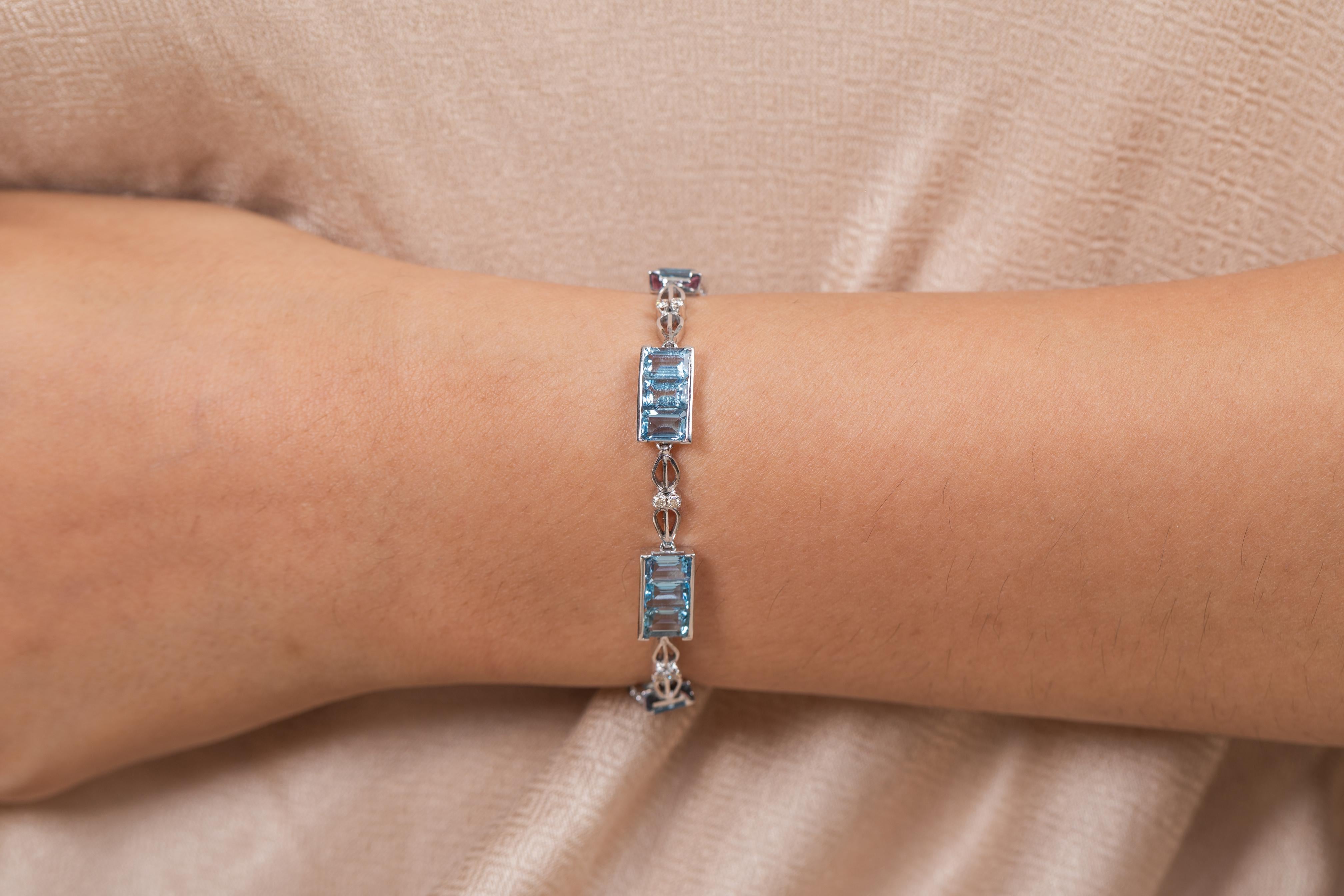 This Aquamarine Diamond Tennis Bracelet in 18K gold showcases 21 endlessly sparkling natural aquamarines, weighing 10.84 carats and 14 pieces of diamonds weighing 0.31 carats. It measures 7.75 inches long in length. 
Aquamarine is useful for moving