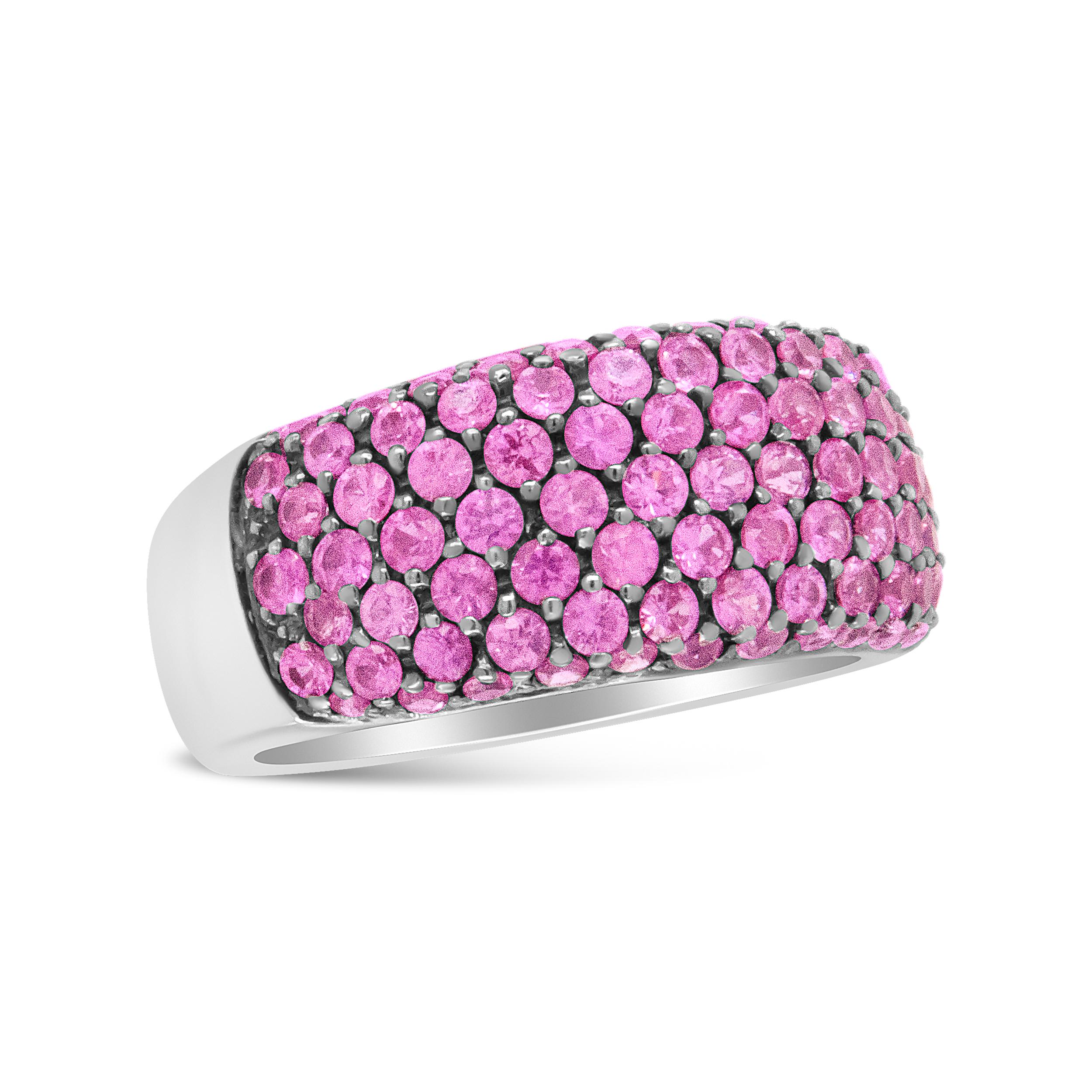 A unique upgrade to a classic diamond band is this beautiful white gold ring set with pink sapphires. The sapphires are striking against the luxurious 18k white gold band, with a beaded gold design interloping the stones. Elevate your jewelry